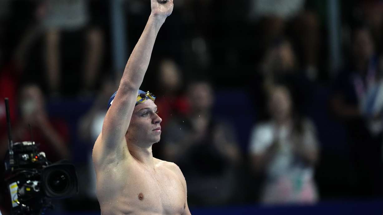 Leon Marchand, of France, celebrates after winning the men's 200-meter butterfly final at the 2024 Summer Olympics, Wednesday, July 31, 2024, in Nanterre, France.