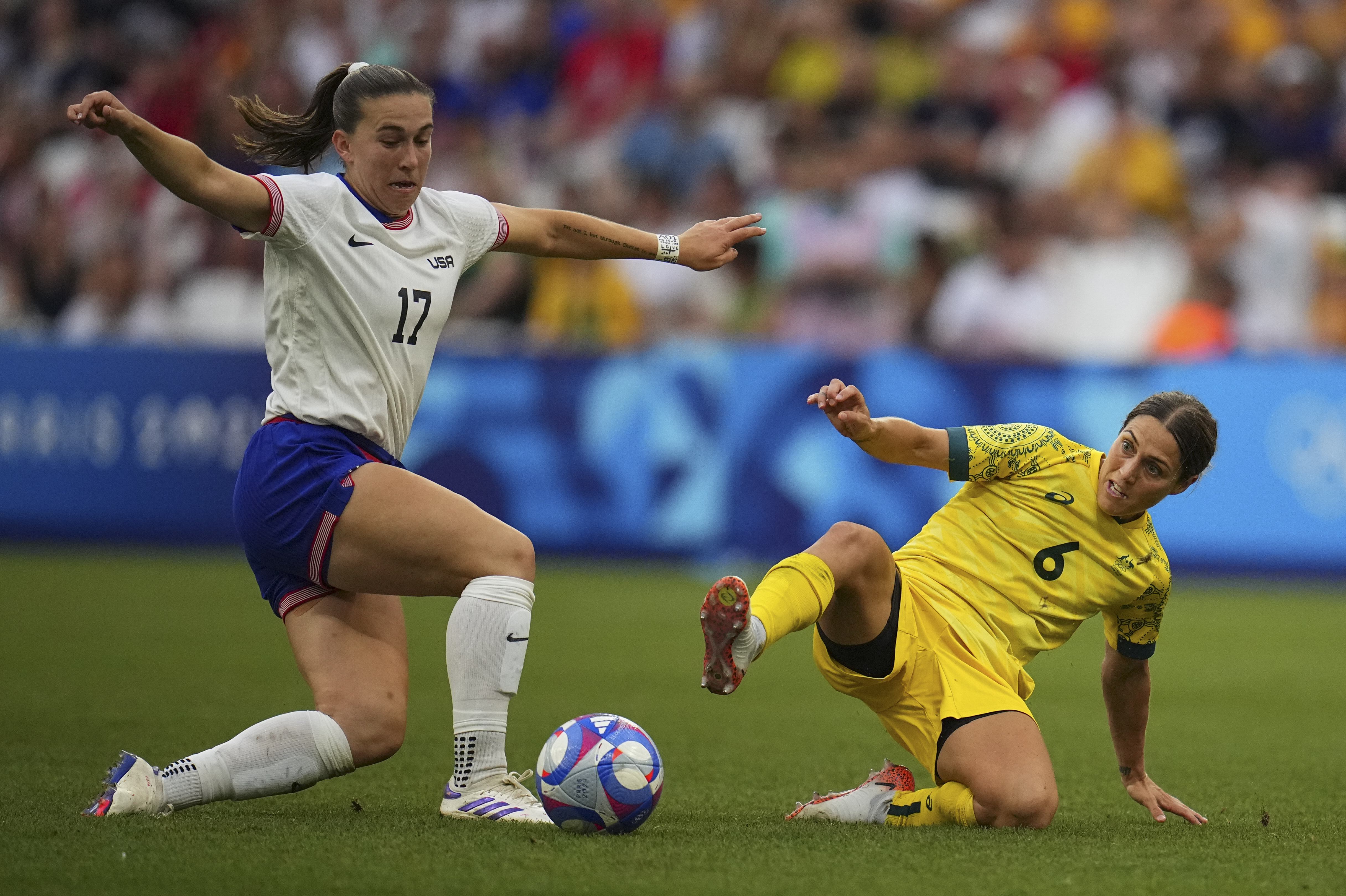 Australia's Katrina Gorry, right, challenges United States' Samantha Coffey during a women's Group B soccer match between Australia and the United States, at the Marseille Stadium, at the 2024 Summer Olympics, Wednesday, July 31, 2024, in Marseille, France. 