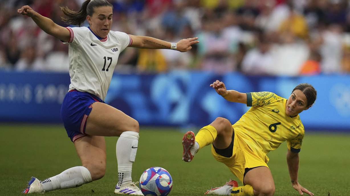 Australia's Katrina Gorry, right, challenges United States' Samantha Coffey during a women's Group B soccer match between Australia and the United States, at the Marseille Stadium, at the 2024 Summer Olympics, Wednesday, July 31, 2024, in Marseille, France.