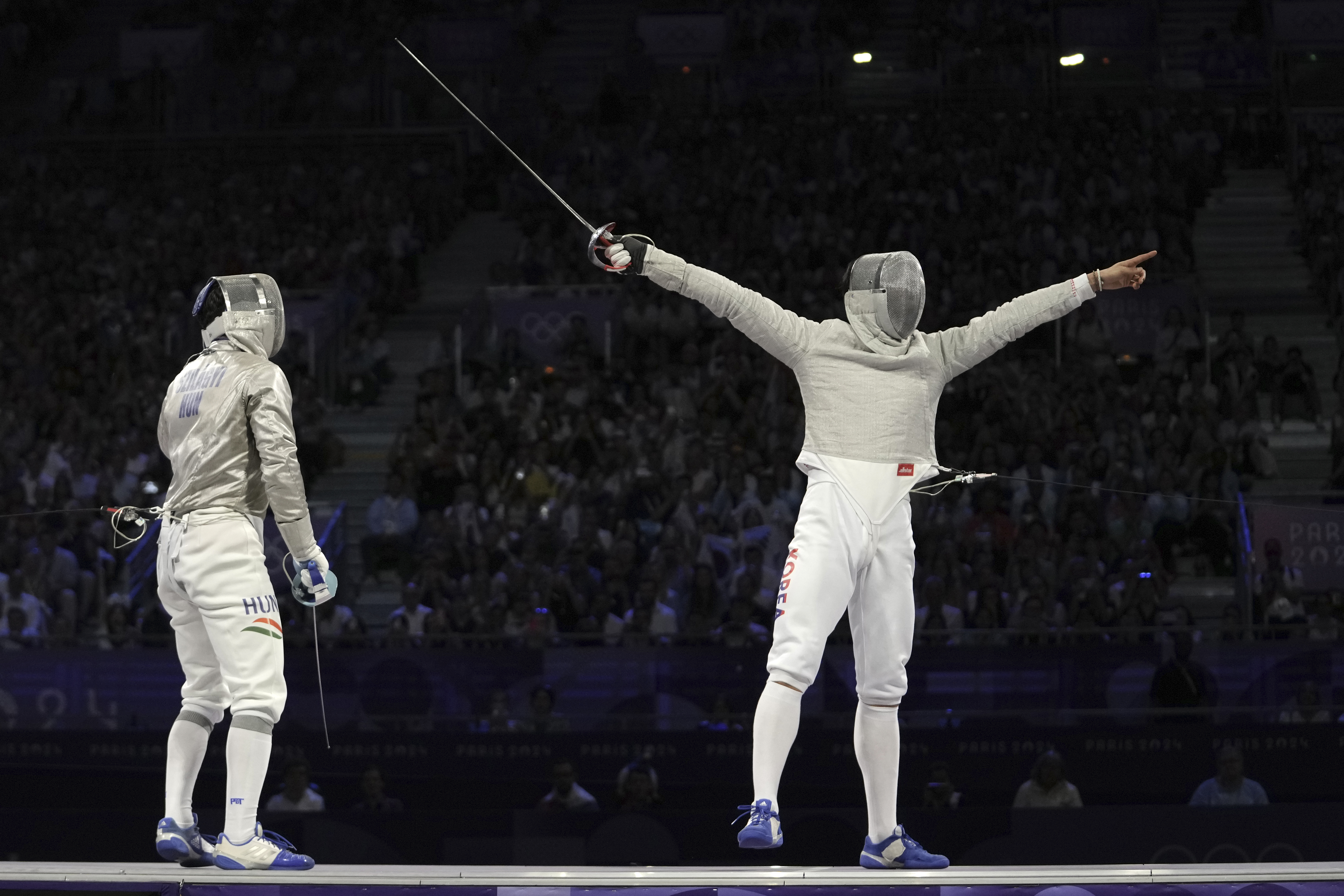 South Korea's Oh Sanguk, right, celebrates after winning the men's team sabre final match against Hungary during the 2024 Summer Olympics at the Grand Palais, Wednesday, July 31, 2024, in Paris, France.