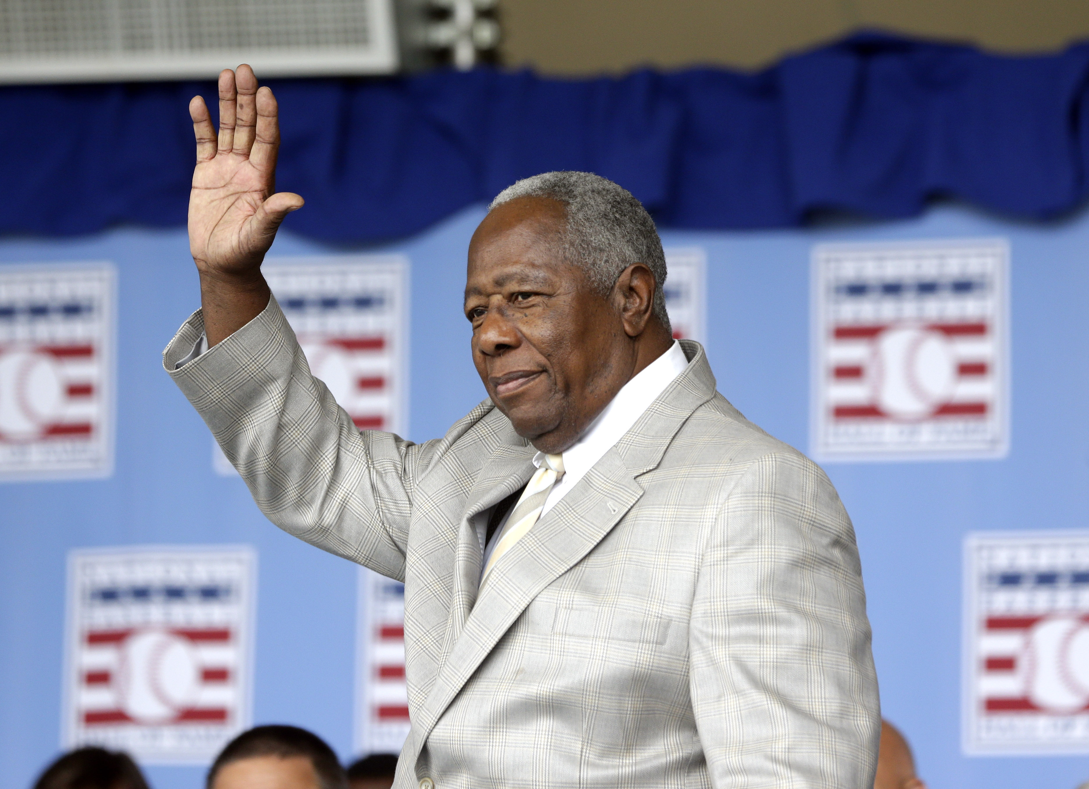 FILE - Hall of Famer Hank Aaron waves to the crowd during the Baseball Hall of Fame induction ceremony on Sunday, July 28, 2013, in Cooperstown, N.Y. The Atlanta Braves launched Hank Aaron Week on Wednesday, July 31, 2024, when the U.S. Postal Service dedicated a commemorative forever stamp honoring Aaron during a ceremony at Truist Park. 