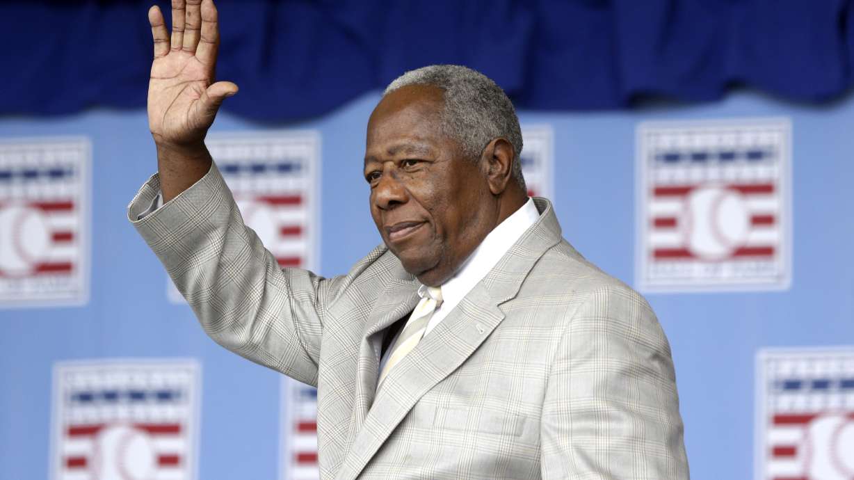 FILE - Hall of Famer Hank Aaron waves to the crowd during the Baseball Hall of Fame induction ceremony on Sunday, July 28, 2013, in Cooperstown, N.Y. The Atlanta Braves launched Hank Aaron Week on Wednesday, July 31, 2024, when the U.S. Postal Service dedicated a commemorative forever stamp honoring Aaron during a ceremony at Truist Park.