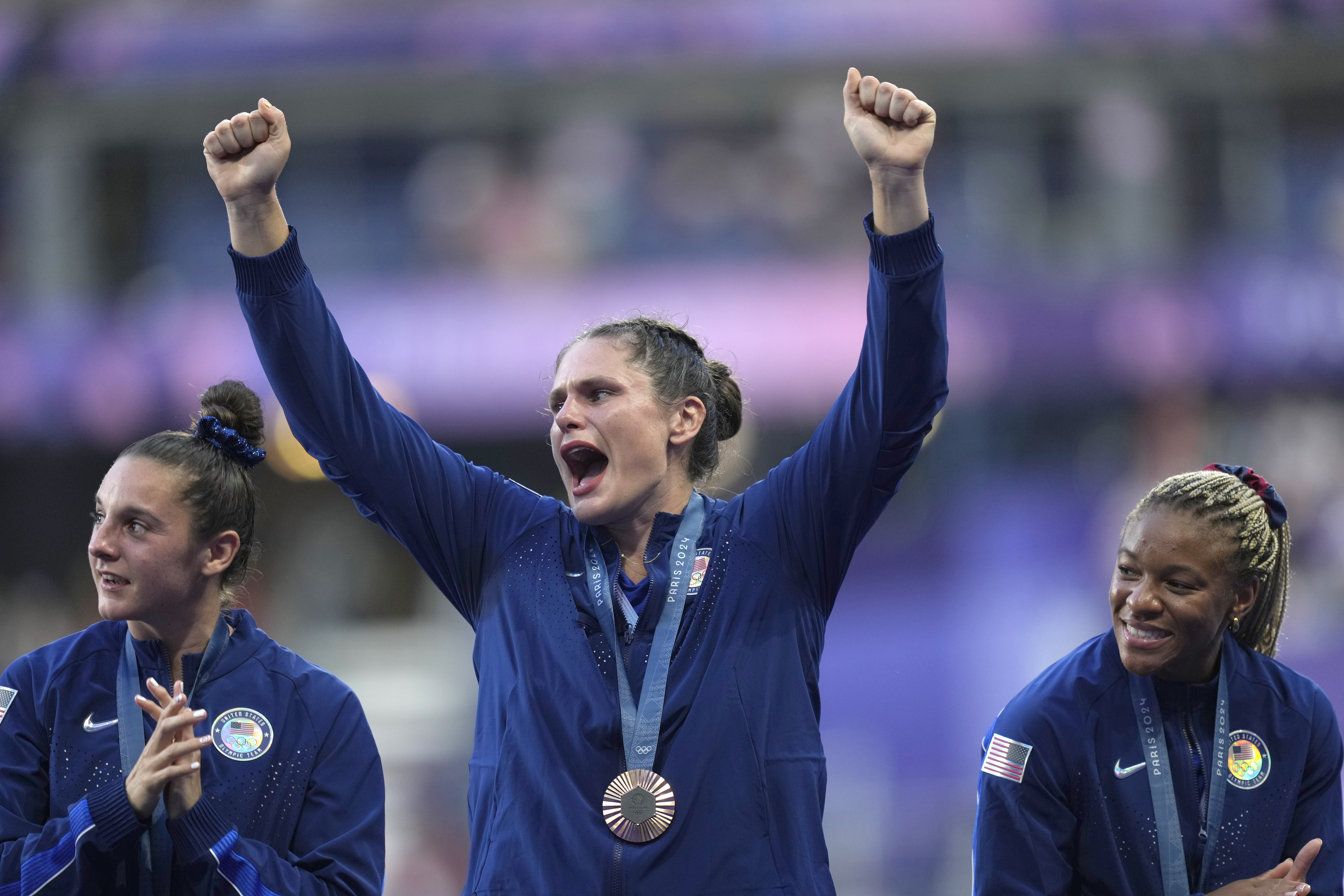 United States' Ilona Maher, centre reacts as she stands on the podium with her bronze medal during the presentation ceremony Rugby Sevens at the 2024 Summer Olympics, in the Stade de France, in Saint-Denis, France, Tuesday, July 30, 2024. 