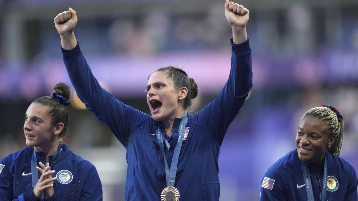 United States' Ilona Maher, centre reacts as she stands on the podium with her bronze medal during the presentation ceremony Rugby Sevens at the 2024 Summer Olympics, in the Stade de France, in Saint-Denis, France, Tuesday, July 30, 2024.
