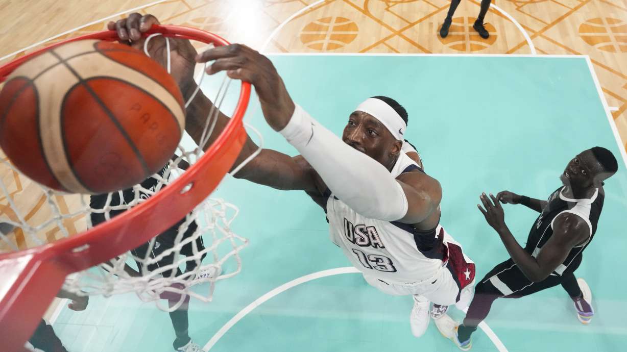 Bam Adebayo, of the United States, puts in a basket in front of Peter Jok, of South Sudan, in a men's basketball game at the 2024 Summer Olympics, Wednesday, July 31, 2024, in Villeneuve-d'Ascq, France.