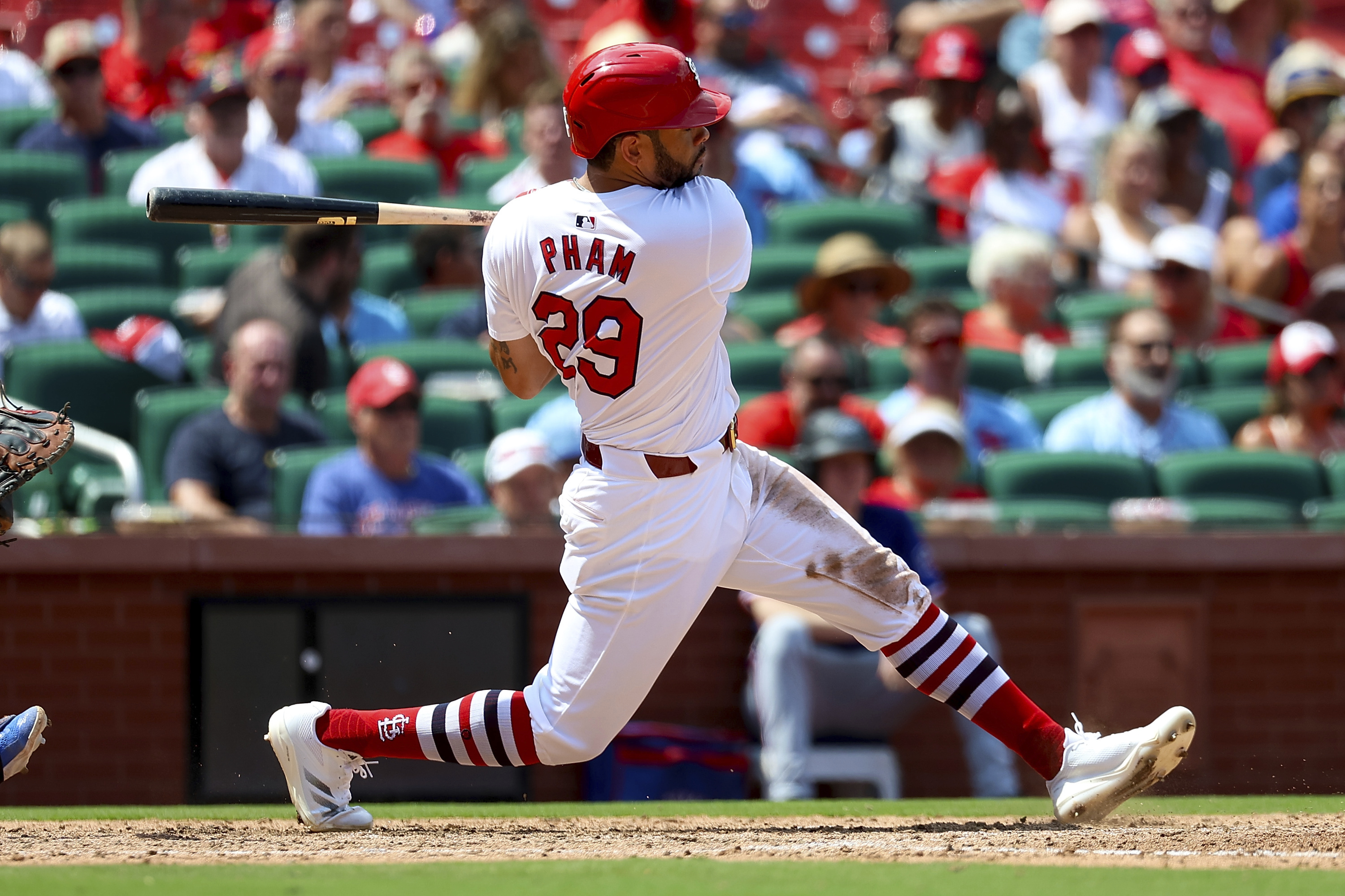 St. Louis Cardinals' Tommy Pham hits a two-RBI double during the fifth inning of a baseball game against the Texas Rangers, Wednesday, July 31, 2024, in St. Louis. 