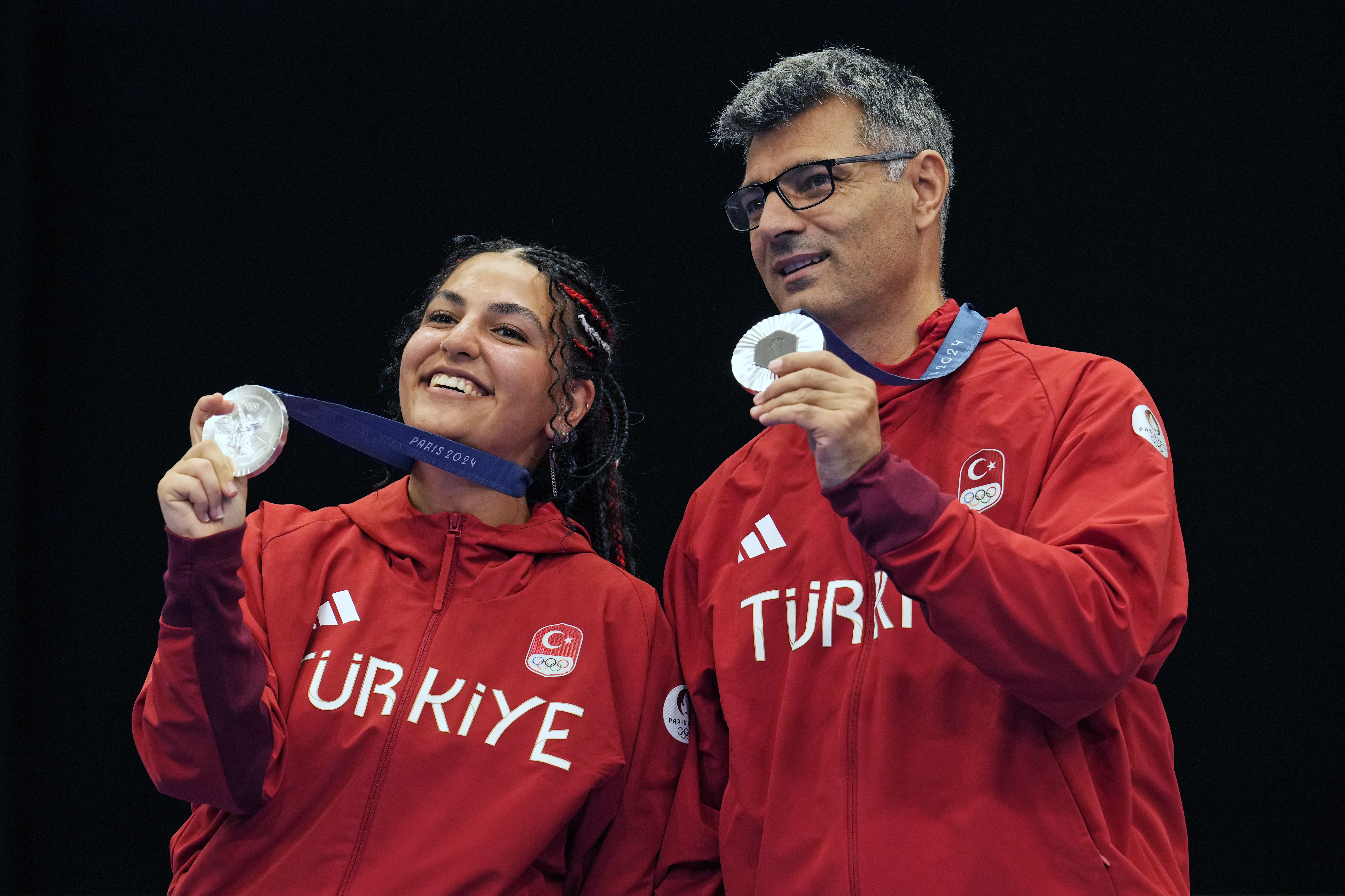 Turkey's Savval Ilayda Tarhan, left, and Yususf Dikec pose for a photograph after winning the silver medal in the 10m air pistol mixed team event at the 2024 Summer Olympics, Tuesday, July 30, 2024, in Chateauroux, France. 