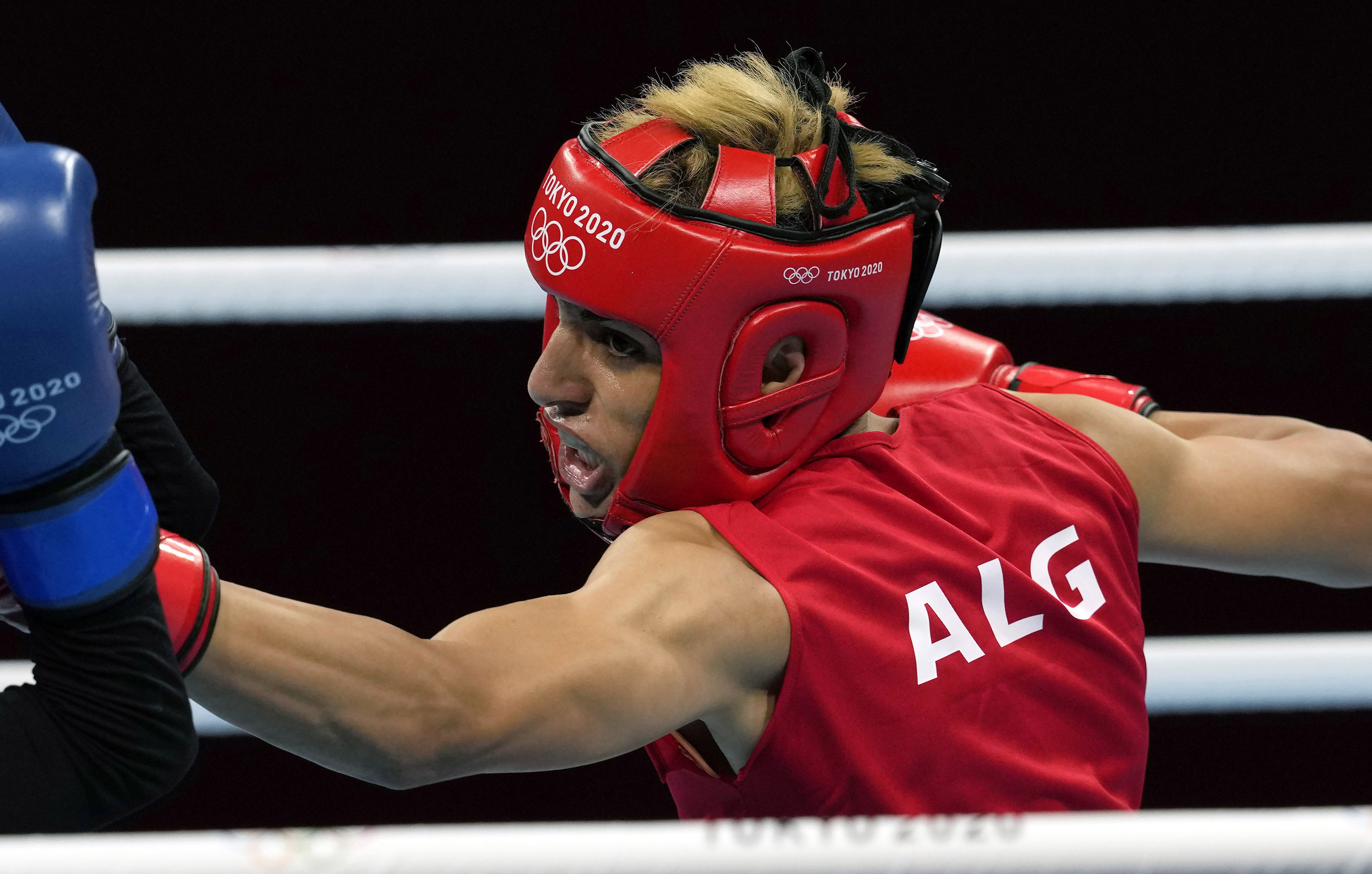 FILE - Imane Khelif, of Algeria, right, delivers a punch to Mariem Homrani Ep Zayani, of Turkey, during their women's light weight 60kg preliminary boxing match at the 2020 Summer Olympics, Friday, July 30, 2021, in Tokyo, Japan. 