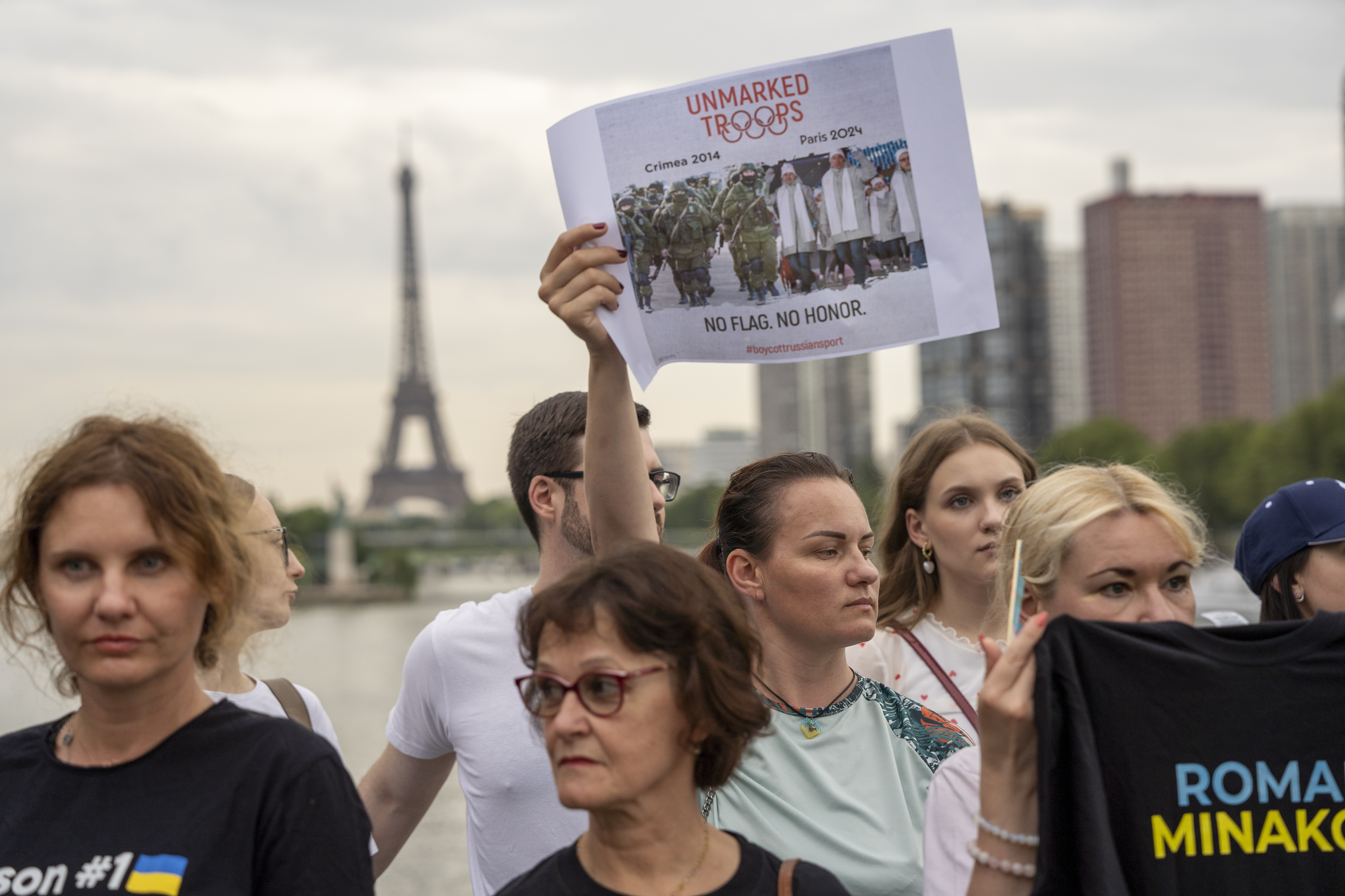 People attend a flash mob to highlight the plight of hundreds of Ukrainian athletes and coaches, both amateur and professional, who were killed as a result of Russia's war in Ukraine in Paris, France, Wednesday, July 31, 2024, during the 2024 Summer Olympics. 