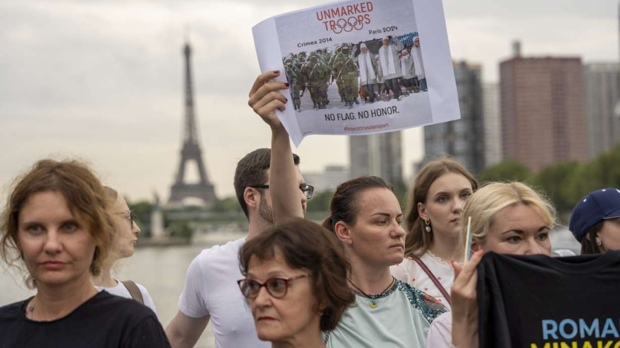 People attend a flash mob to highlight the plight of hundreds of Ukrainian athletes and coaches, both amateur and professional, who were killed as a result of Russia's war in Ukraine in Paris, France, Wednesday, July 31, 2024, during the 2024 Summer Olympics.