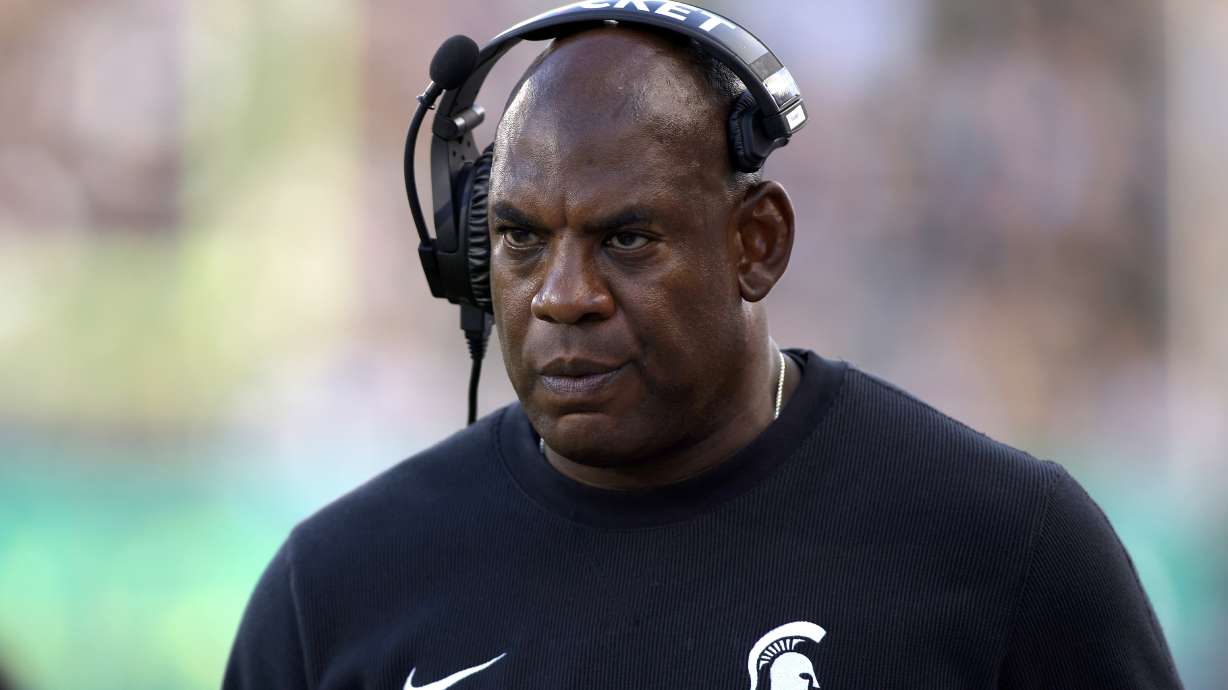 FILE - Michigan State coach Mel Tucker walks the sideline during the second half of an NCAA college football game against Richmond, on Sept. 9, 2023, in East Lansing, Mich. Former Michigan State University head football coach Mel Tucker is suing the university and school leaders, alleging that they wrongfully fired him last year and violated his constitutional rights amid a sexual harassment case. The federal lawsuit filed Wednesday, July 31, 2024, in Michigan accuses school officials of undertaking an “improper, sham investigation” of allegations that Tucker sexually harassed and exploited rape survivor and activist Brenda Tracy.