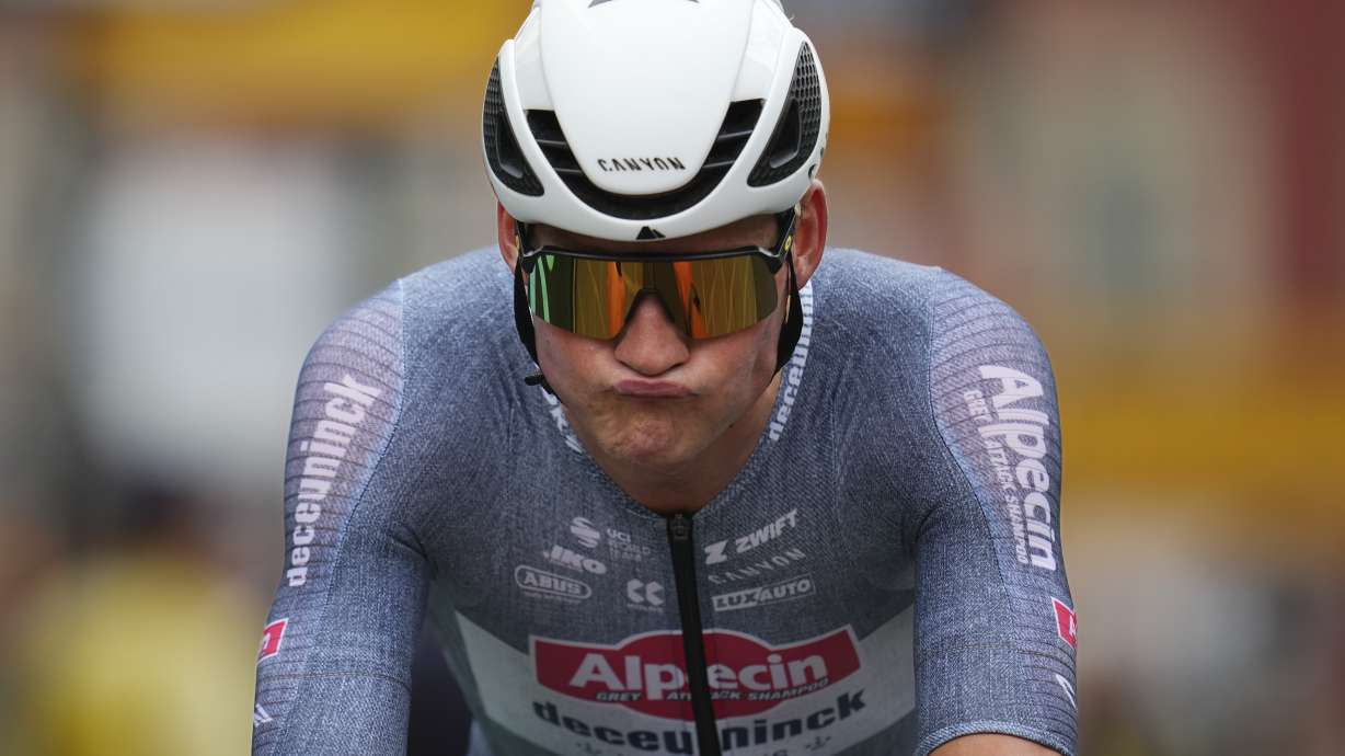 Netherlands' Mathieu van der Poel reacts after crossing the finish line of the twenty-first stage of the Tour de France cycling race, an individual time trial over 33.7 kilometers (20.9 miles) with start in Monaco and finish in Nice, France, Sunday, July 21, 2024.
