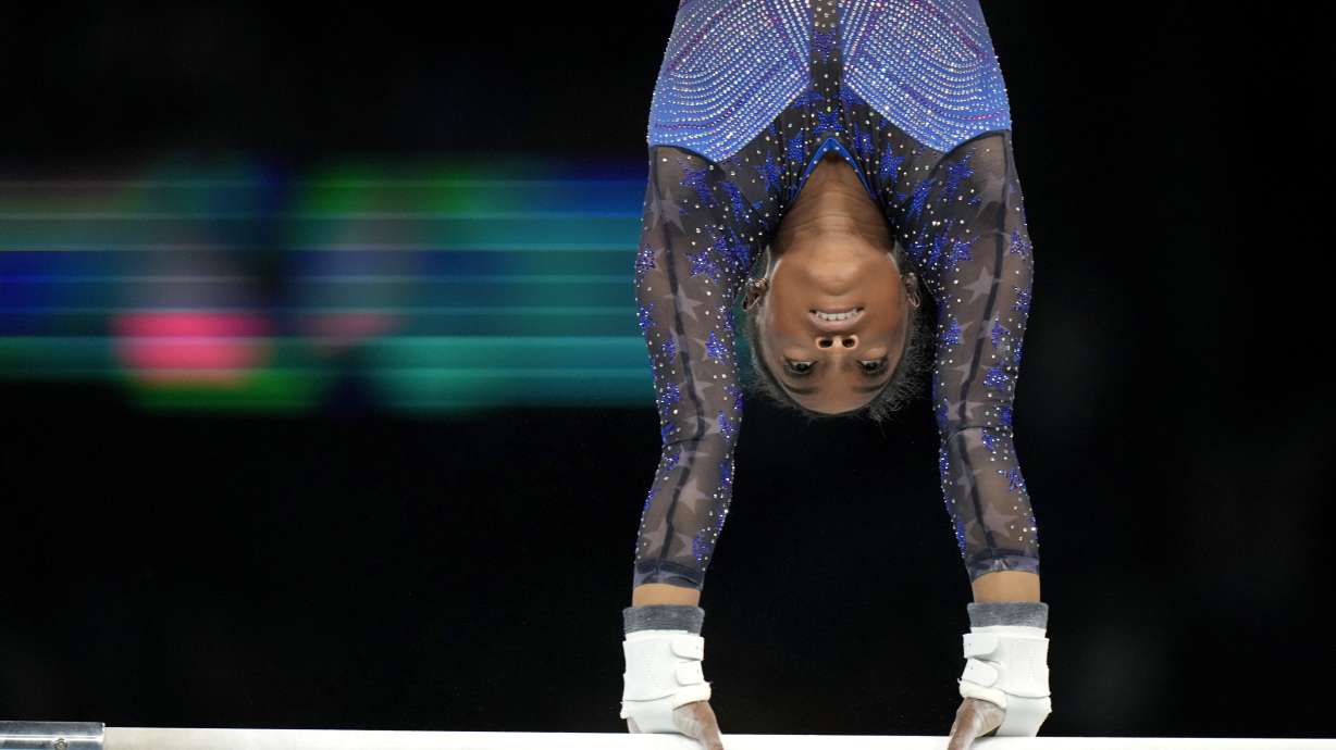 Simone Biles, of the United States, warms up on uneven bars during the women's artistic gymnastics all-around finals in Bercy Arena at the 2024 Summer Olympics, Thursday, Aug. 1, 2024, in Paris, France.