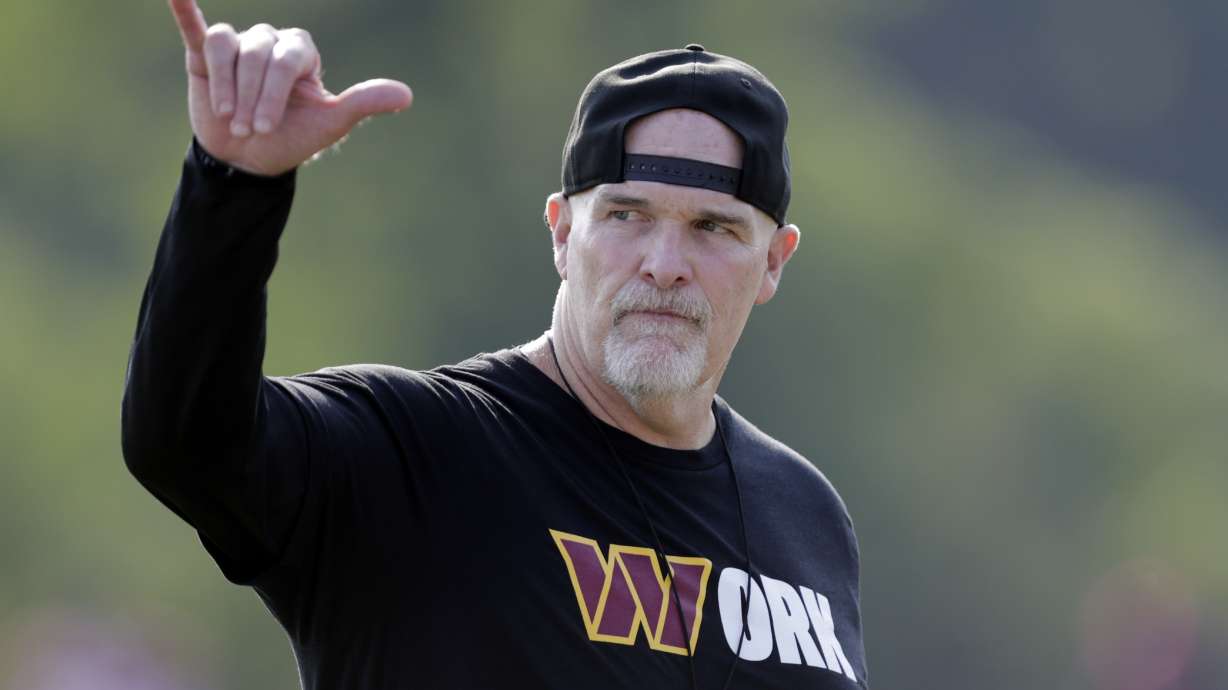 Washington Commanders head coach Dan Quinn gestures during NFL football practice at the team's training facility in Ashburn, Va., Thursday, Aug. 1, 2024.