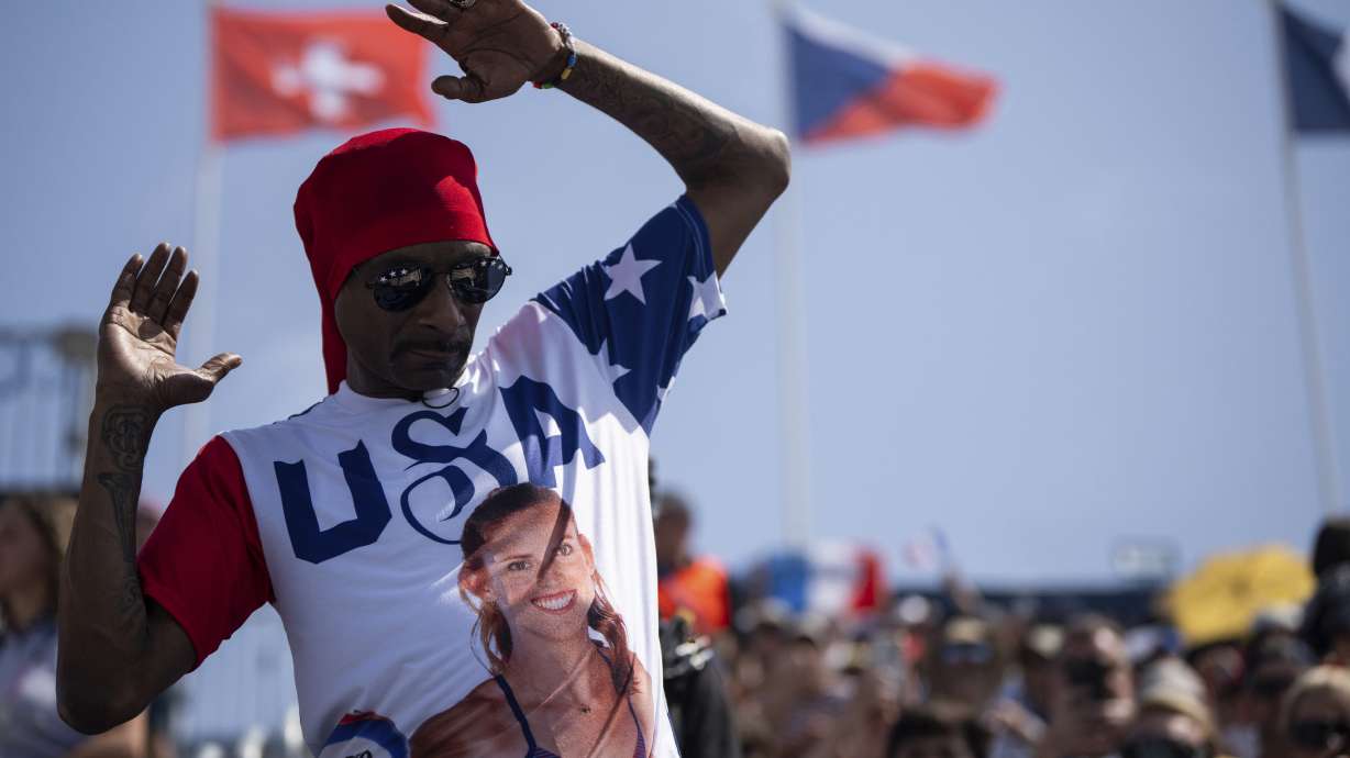 Snoop Dogg attends the women's pool C beach volleyball match between USA and France at Eiffel Tower Stadium at the 2024 Summer Olympics, Wednesday, July 31, 2024, in Paris, France.