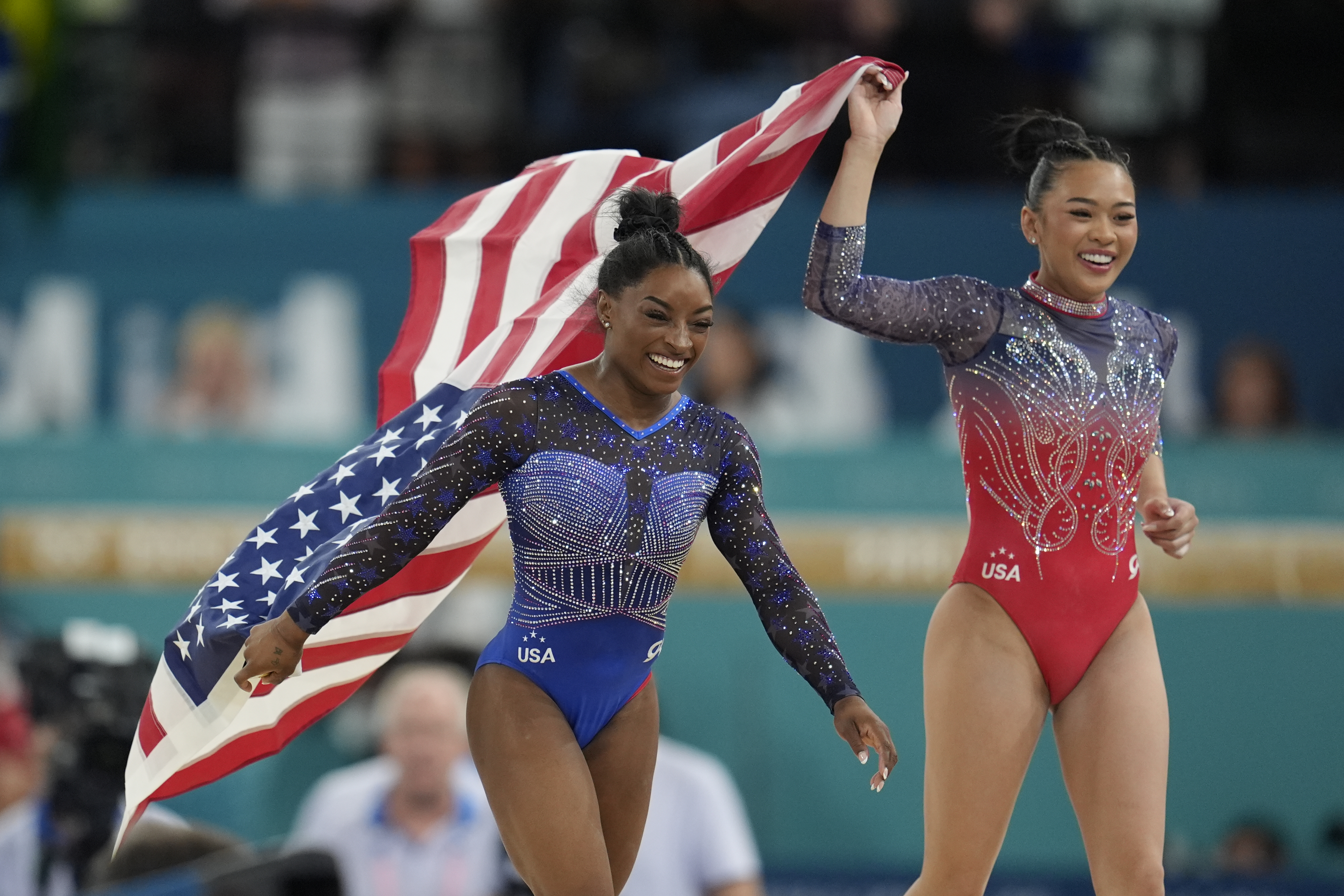 Simone Biles, left, celebrates with teammate Suni Lee, of the United States, after winning the gold and bronze medals respectively in the women's artistic gymnastics all-around finals in Bercy Arena at the 2024 Summer Olympics, Thursday, Aug. 1, 2024, in Paris, France. 