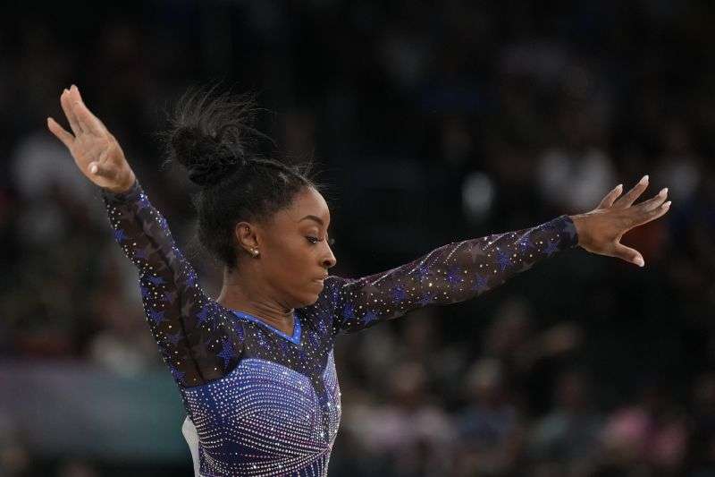 Simone Biles, of the United States, performs on the floor during the women's artistic gymnastics all-around finals in Bercy Arena at the 2024 Summer Olympics, Thursday, in Paris, France.