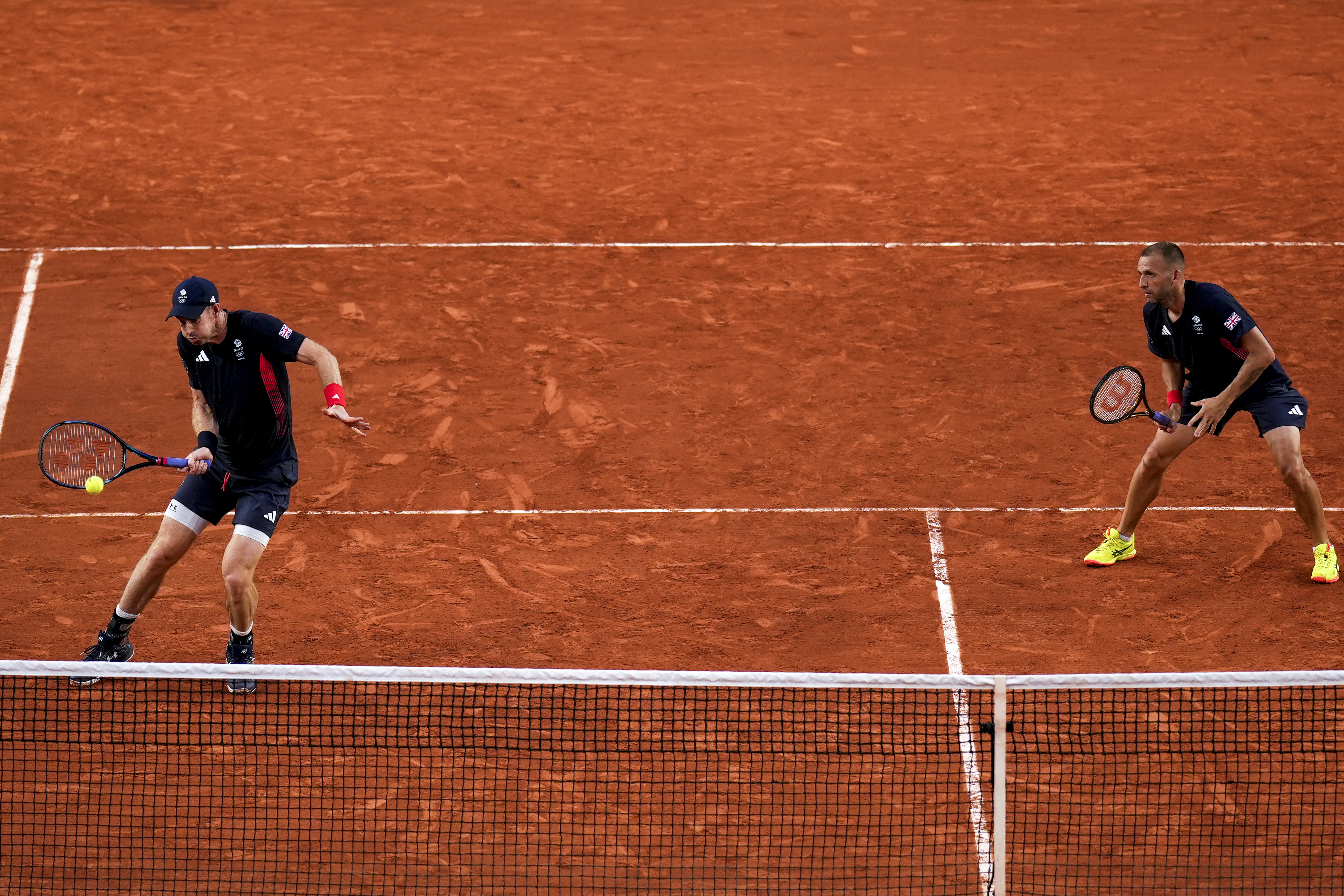 Andy Murray, left, and Daniel Evans of Britain compete against Joran Vliegen and Sander Gille of Belgium during the men's doubles tennis competition at the Roland Garros stadium, at the 2024 Summer Olympics, Tuesday, July 30, 2024, in Paris, France. 