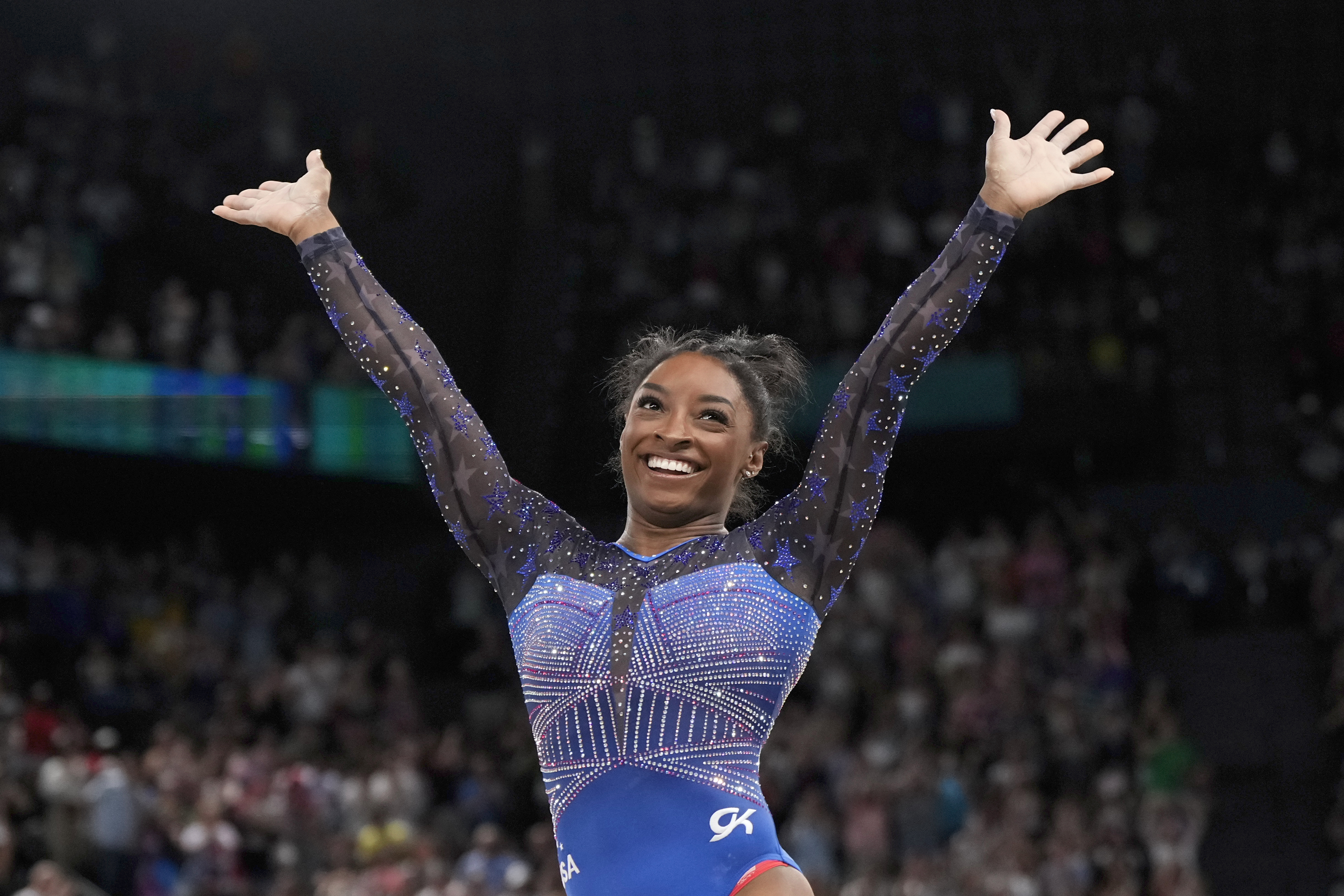 Simone Biles, of the United States, celebrates after performing in the floor exercise during the women's artistic gymnastics all-around finals in Bercy Arena at the 2024 Summer Olympics, Thursday, Aug. 1, 2024, in Paris, France.