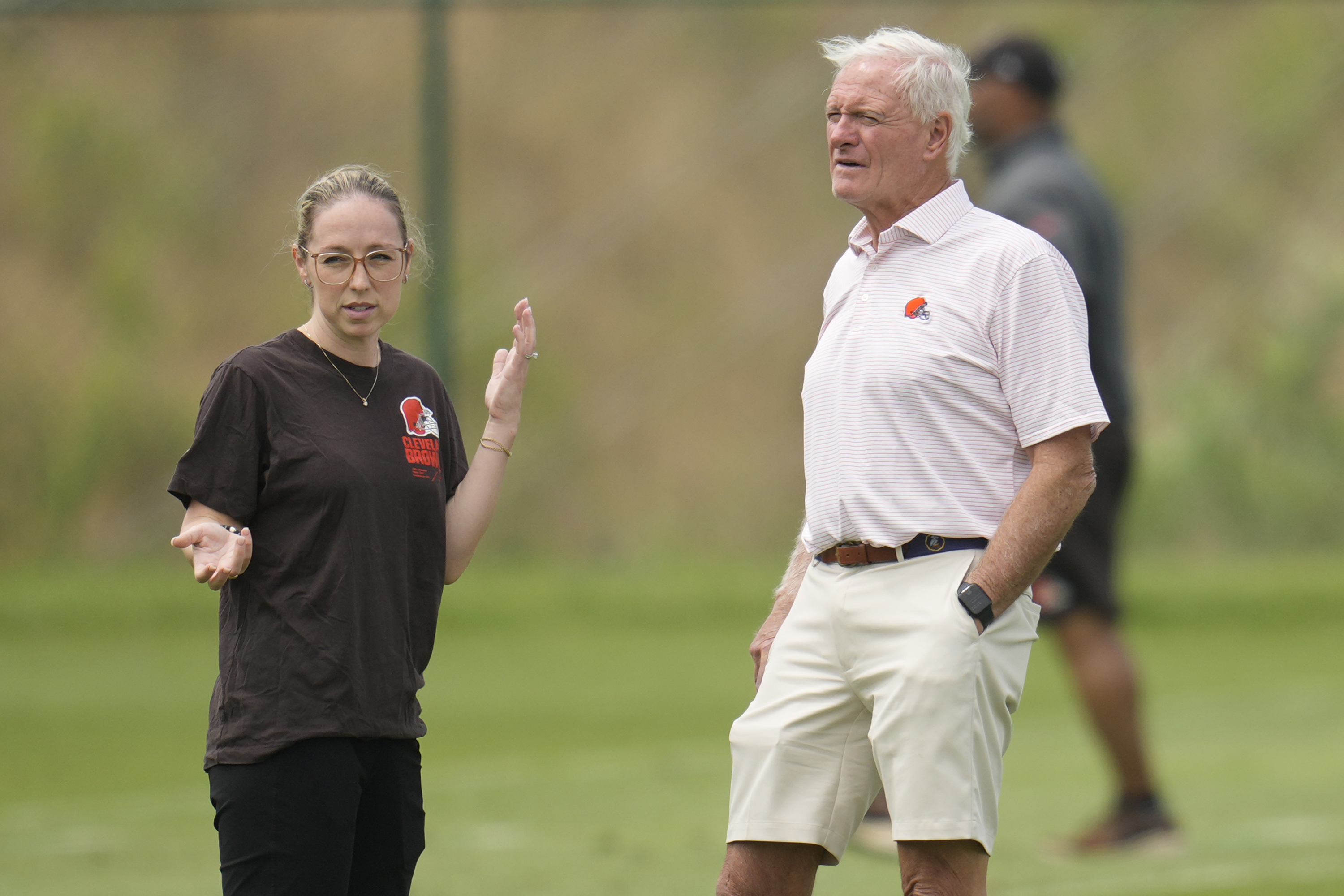 Cleveland Browns owner Jimmy Haslam, right, talks with Catherine Raiche, left, assistant general manager and vice president of football operations, during an NFL football training camp practice Saturday, July 27, 2024, in White Sulphur Springs, W.Va. 