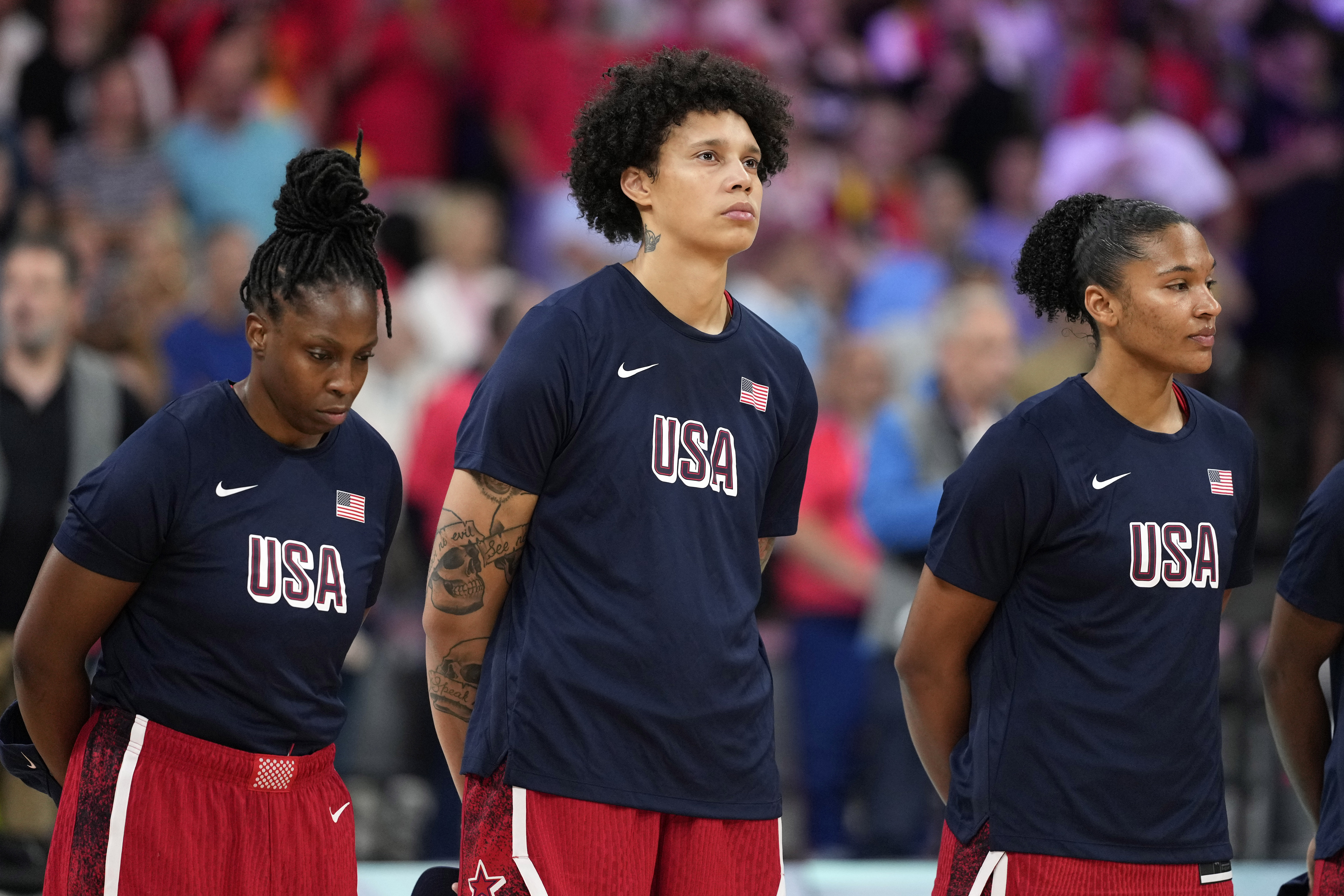 United States' Brittney Griner, center, stands on the court during the national anthem prior to a women's basketball game against Belgium at the 2024 Summer Olympics, Thursday, Aug. 1, 2024, in Villeneuve-d'Ascq, France.