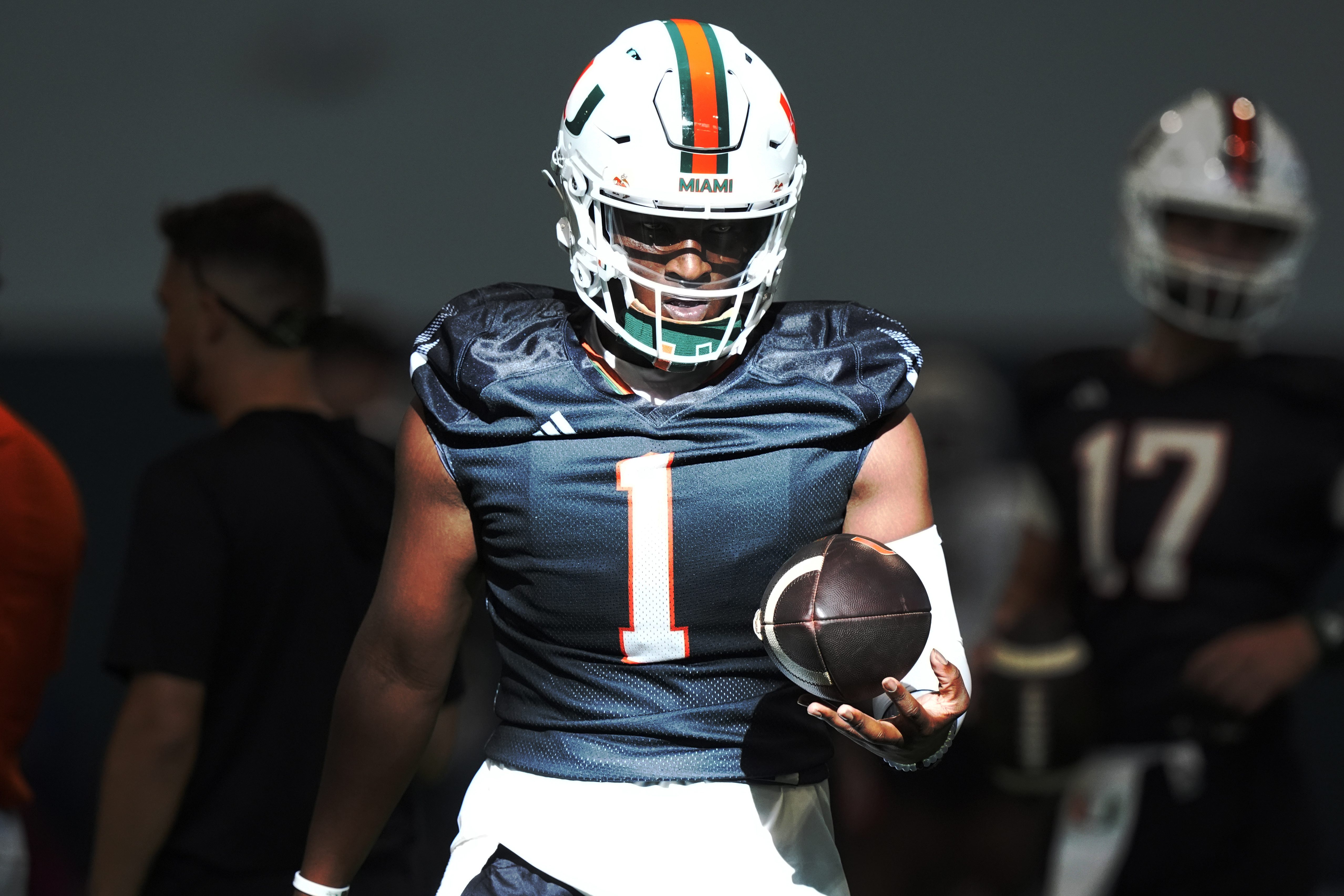 Miami quarterback Cam Ward (1) holds the ball during NCAA college football practice, Wednesday, July 31, 2024, in Coral Gables, Fla. 