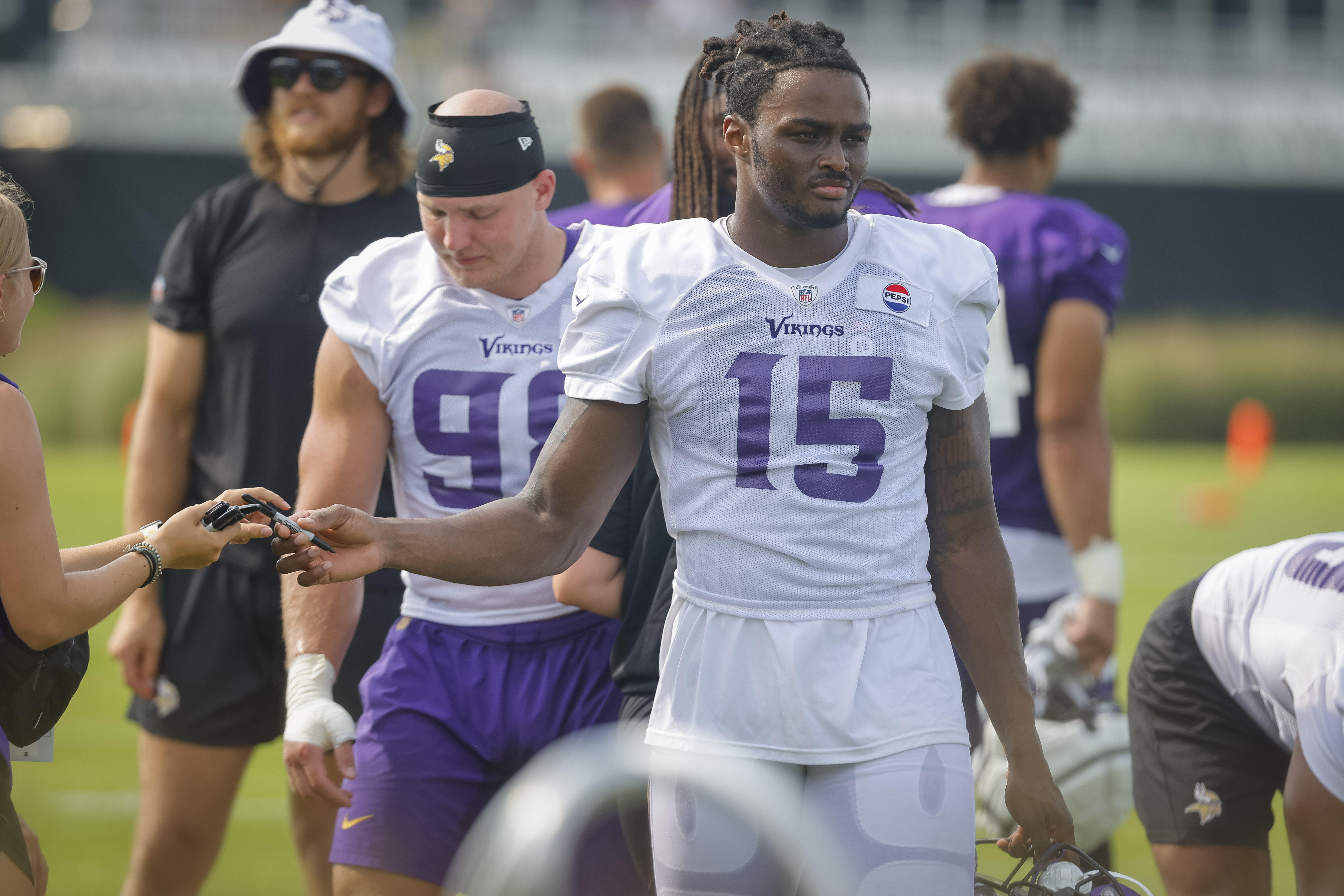 FILE - Minnesota Vikings linebacker Dallas Turner (15) walks to fans after an NFL football training camp Saturday, July 27, 2024, in Eagan, Minn. 