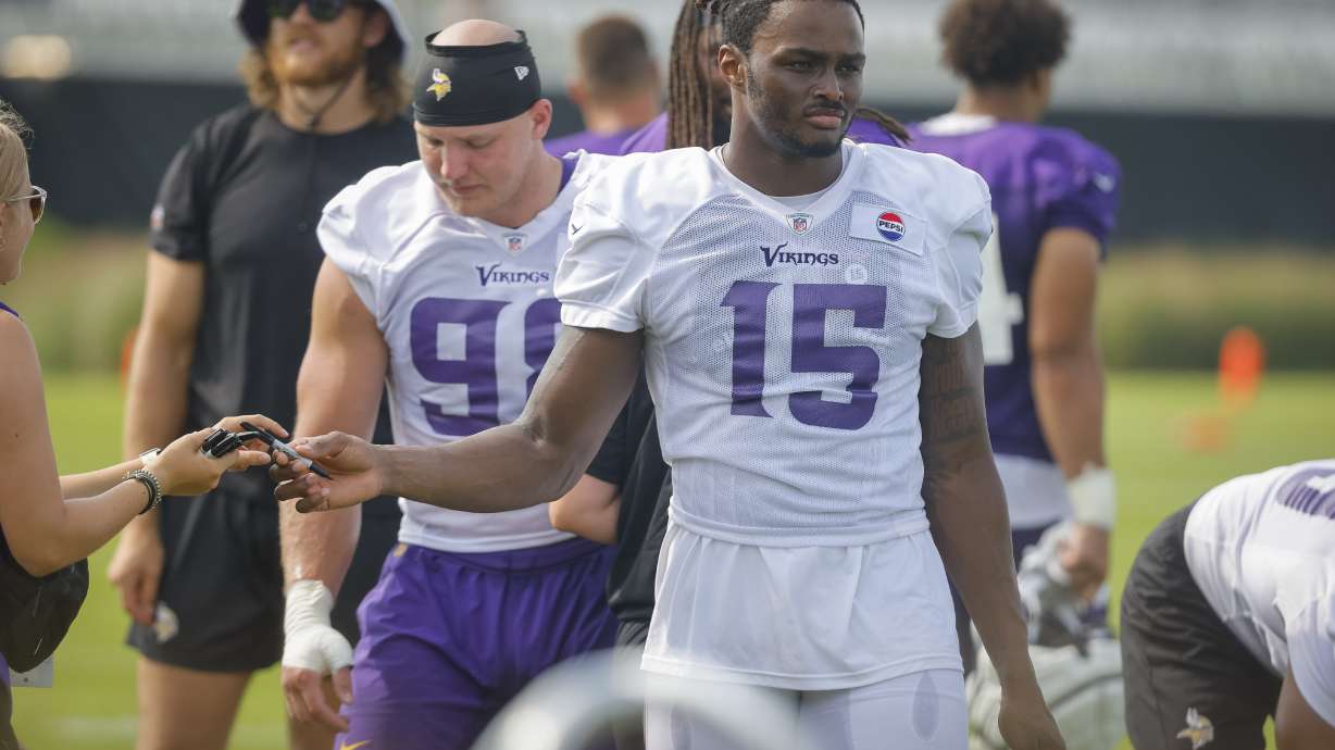 FILE - Minnesota Vikings linebacker Dallas Turner (15) walks to fans after an NFL football training camp Saturday, July 27, 2024, in Eagan, Minn.