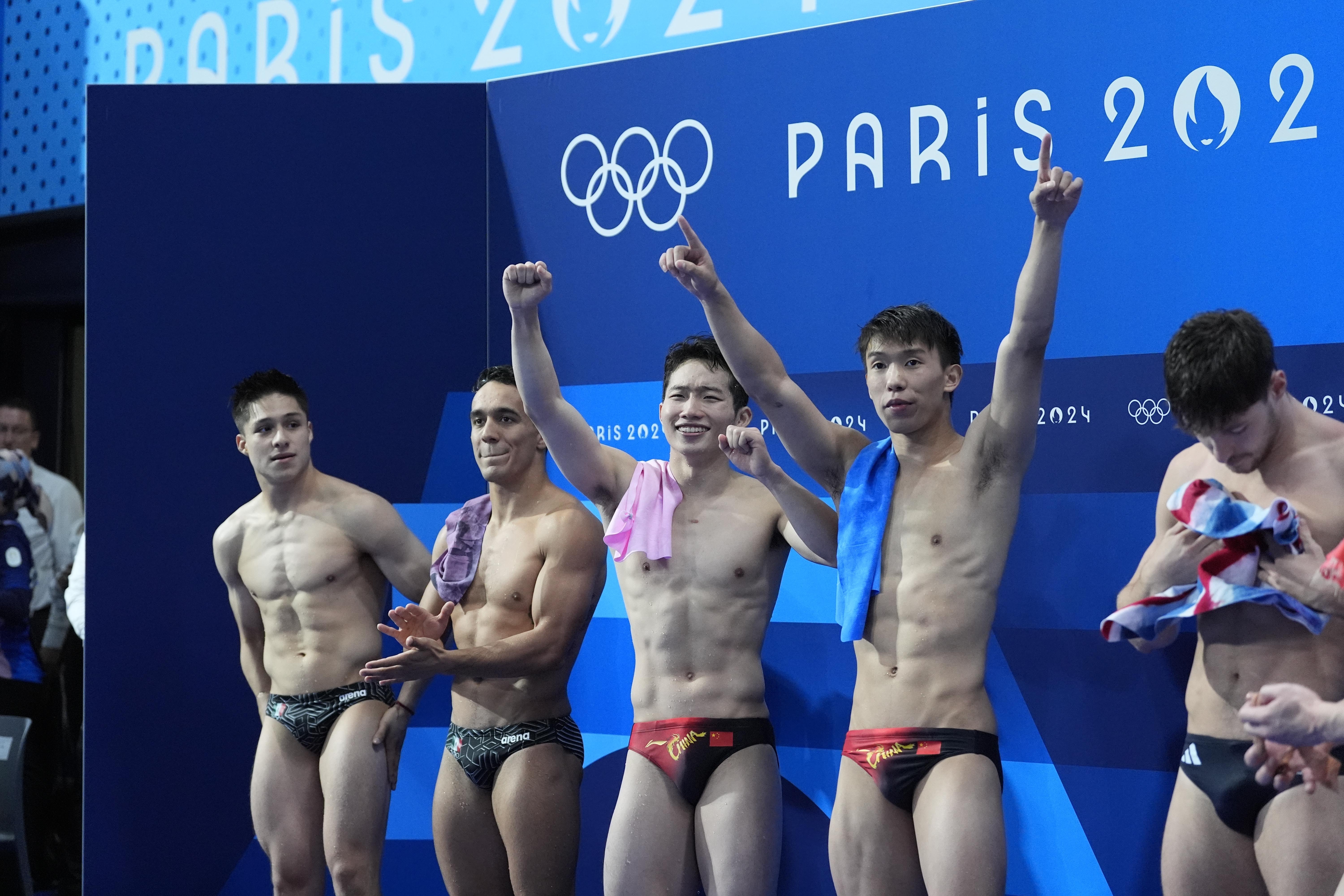 China's Long Daoyi and Wang Zongyuan celebrate after winning the gold medal in the men's synchronised 3m springboard diving final at the 2024 Summer Olympics, Friday, Aug. 2, 2024, in Saint-Denis, France. 