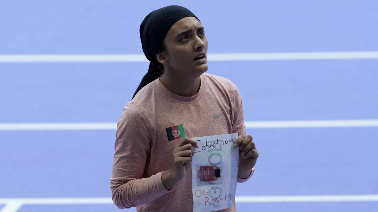 Kimia Yousofi, of Afghanistan, makes a political statement after a heat in the women's 100-meter run at the 2024 Summer Olympics, Friday, Aug. 2, 2024, in Saint-Denis, France.