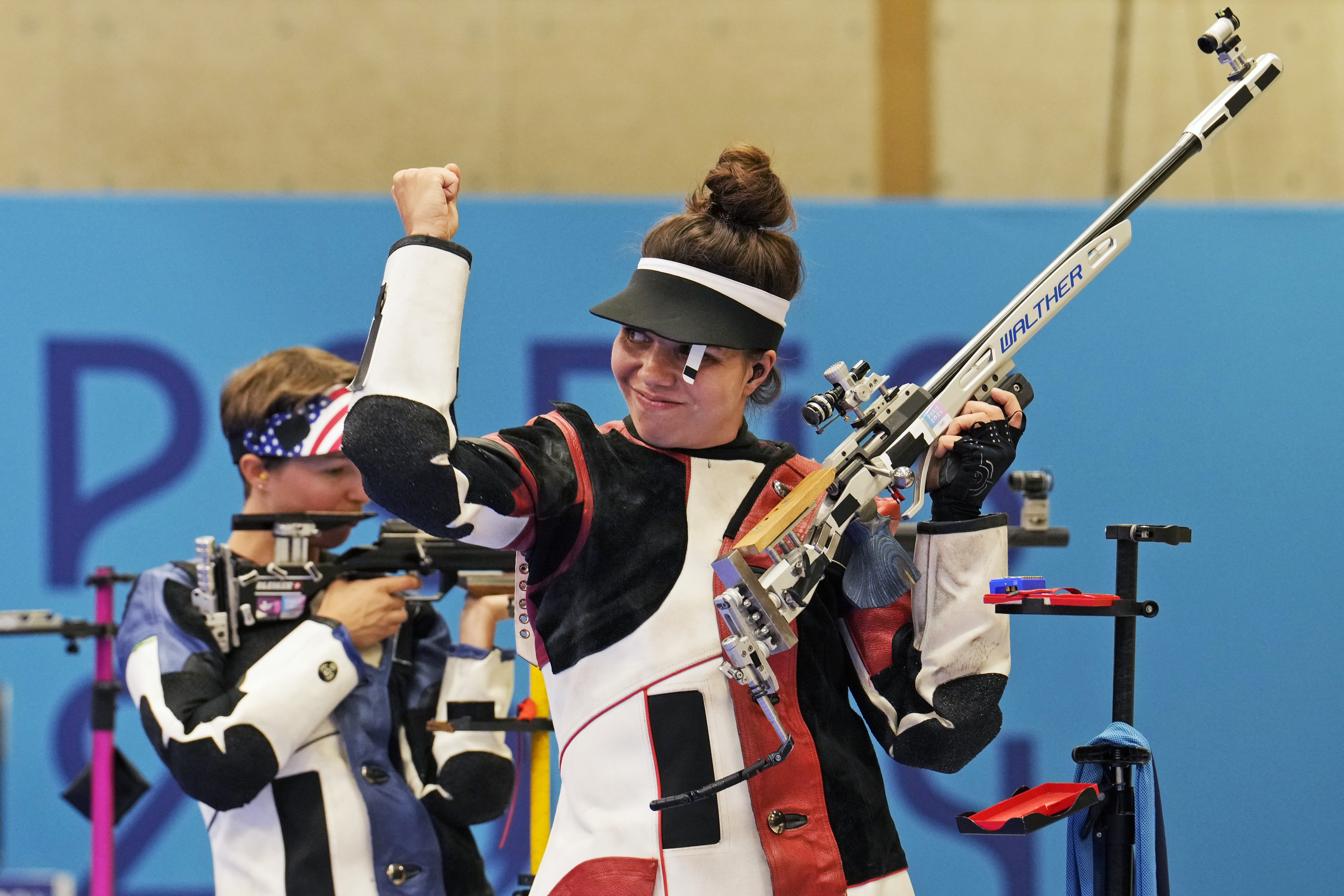 Switzerland's Chiara Leone, right, reacts after winning the gold medal in the 50m rifle 3 positions women's final competition at the 2024 Summer Olympics, Friday, Aug. 2, 2024, in Chateauroux, France. 