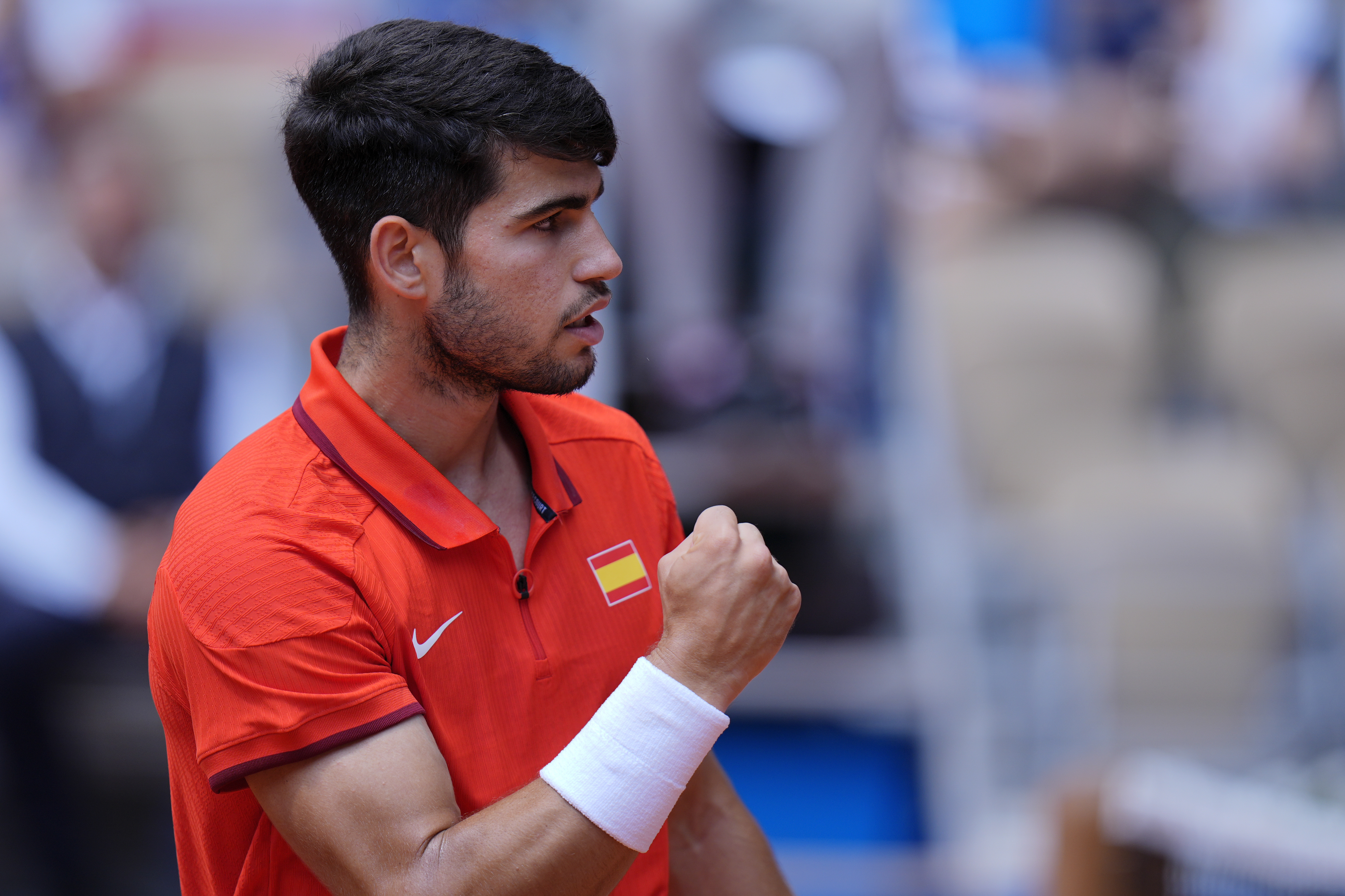 Carlos Alcaraz of Spain reacts after scoring a point against Felix Auger-Aliassime of Canada during their men's singles semifinals tennis match, at the 2024 Summer Olympics, Friday, Aug. 2, 2024, at the Roland Garros stadium in Paris, France. 