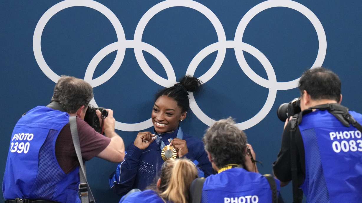 Simone Biles, of the United States, celebrates after winning the gold medal during the women's artistic gymnastics all-around finals in Bercy Arena at the 2024 Summer Olympics, Thursday, Aug. 1, 2024, in Paris, France.