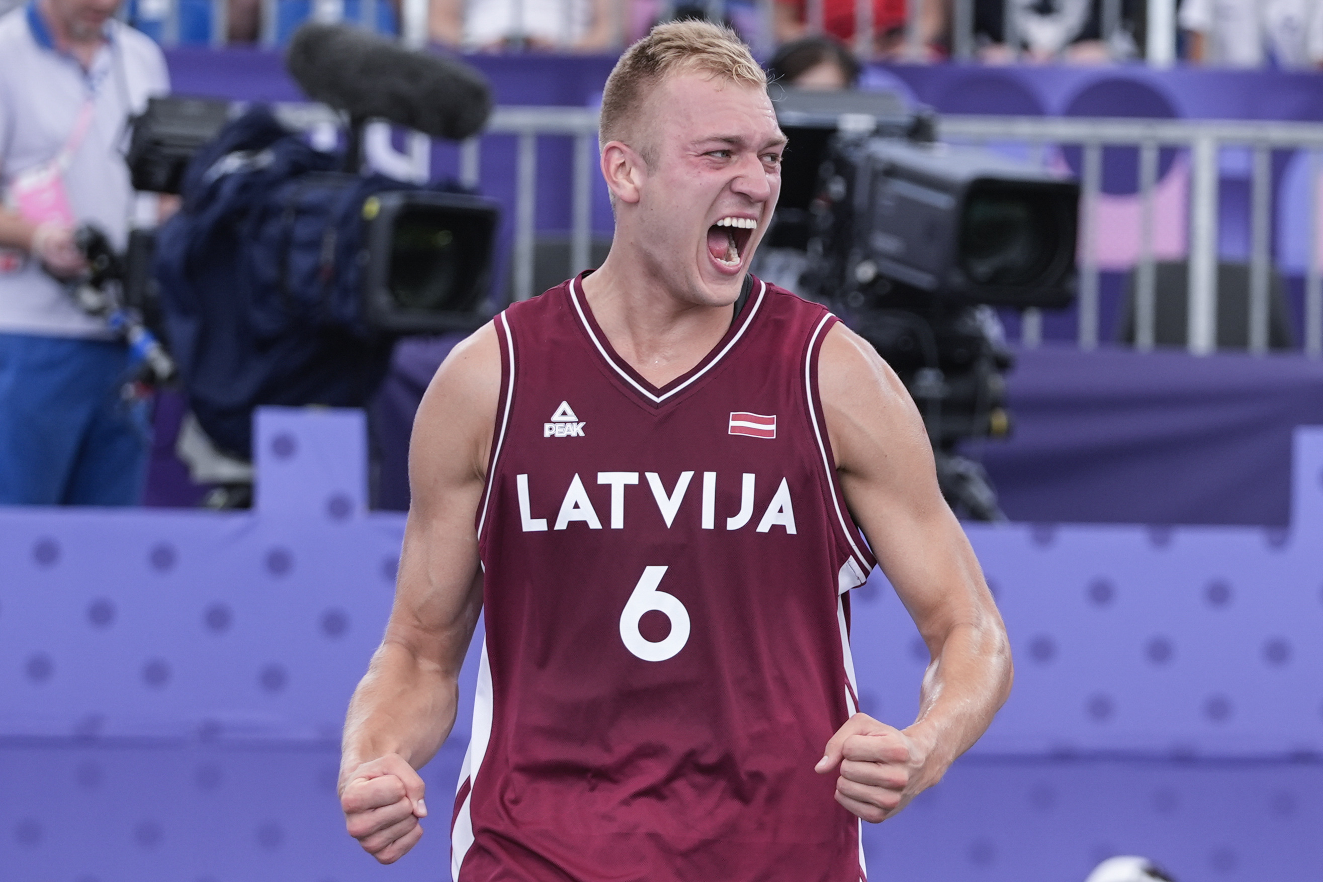 Latvia's Francis Lacis (6) celebrates after a men's 3x3 basketball pool round match against France during the 2024 Summer Olympics, Friday, Aug. 2, 2024, in Paris, France. Latvia won 22-20.