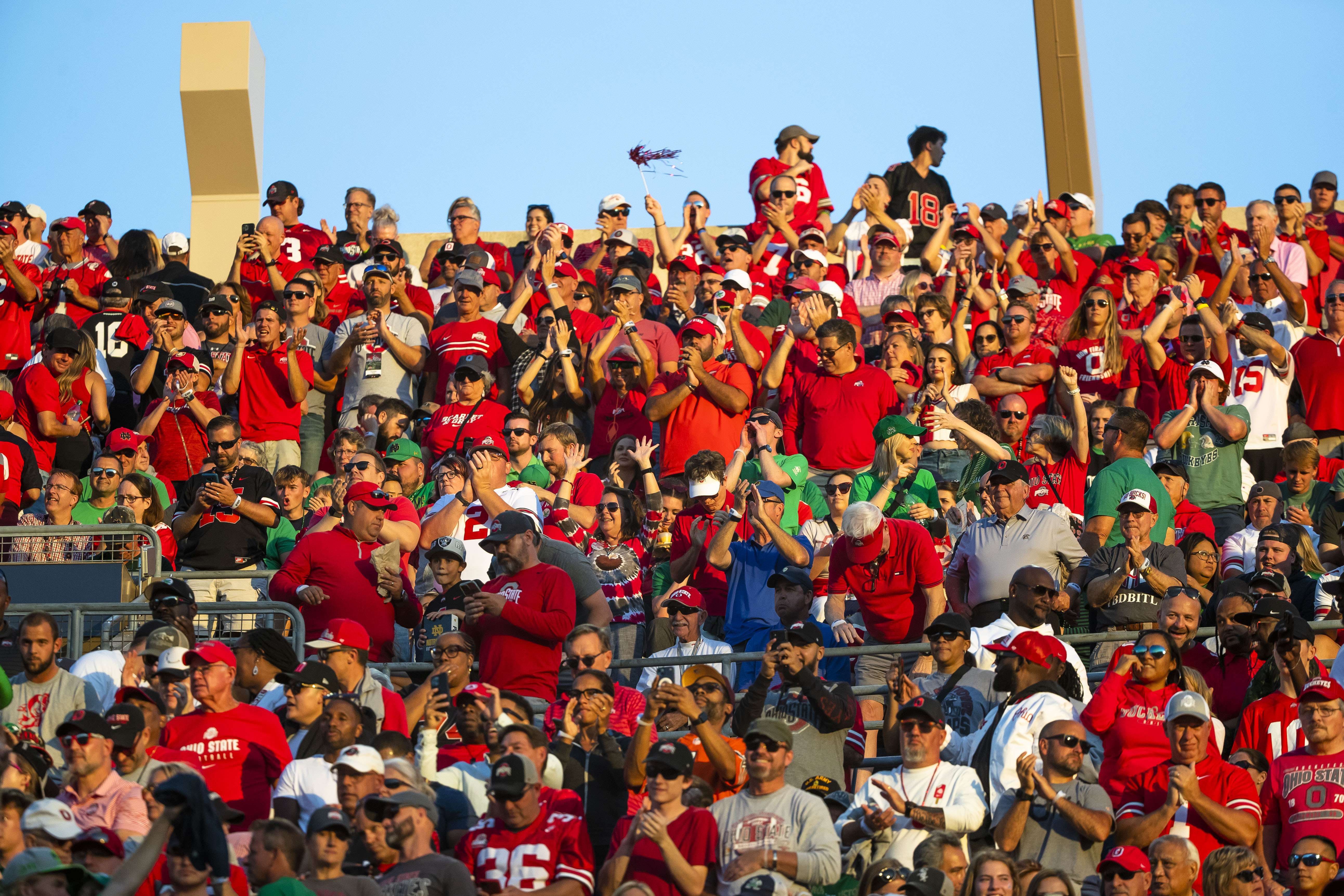 FILE - Ohio State fans cheer during the first half of an NCAA college football game against Notre Dame, Sept. 23, 2023, in South Bend, Ind. Ohio State and Nebraska are opening one or more of their preseason practices and charging admission.