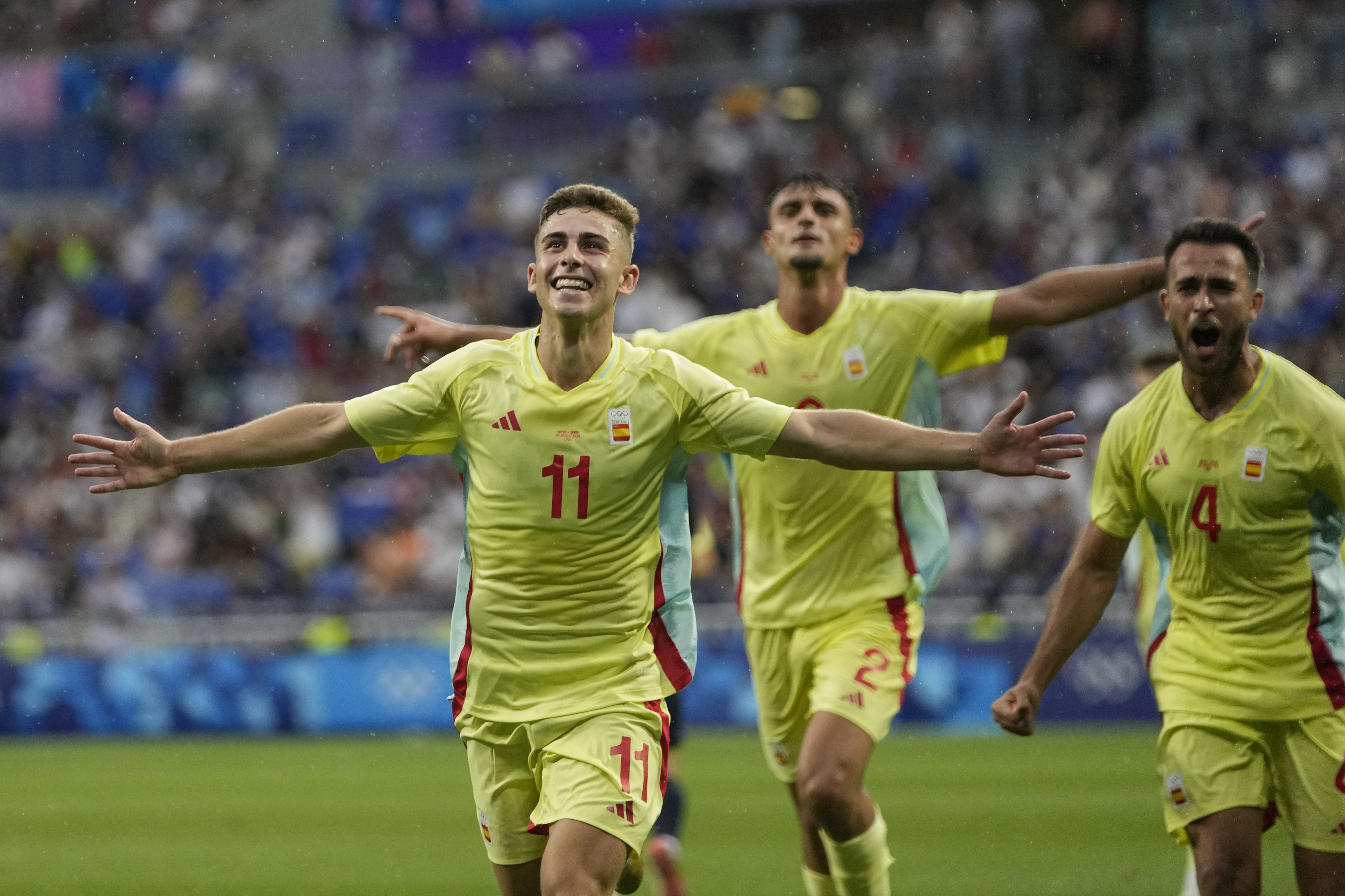 Spain's Fermin Lopez, left, celebrates after scoring his side's 2nd goal during the men's quarter final soccer match between Japan and Spain at the Lyon stadium during the 2024 Summer Olympics, Friday, Aug. 2, 2024, in Decines, France.