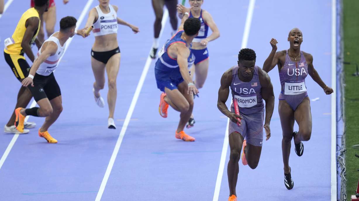 Shamier Little hands off to Bryce Deadmon, of the United States, during a heat in the 4 x 400-meter relay mixed at the 2024 Summer Olympics, Friday, Aug. 2, 2024, in Saint-Denis, France.