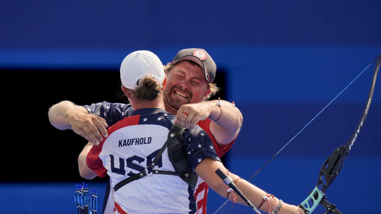 Brady Ellison, of the United States celebrates with Casey Kaufhold after winning the Archery mixed team bronze medal match against India's Ankita Bhakat and Dhiraj Bommadevara at the 2024 Summer Olympics, Friday, Aug. 2, 2024, in Paris, France.