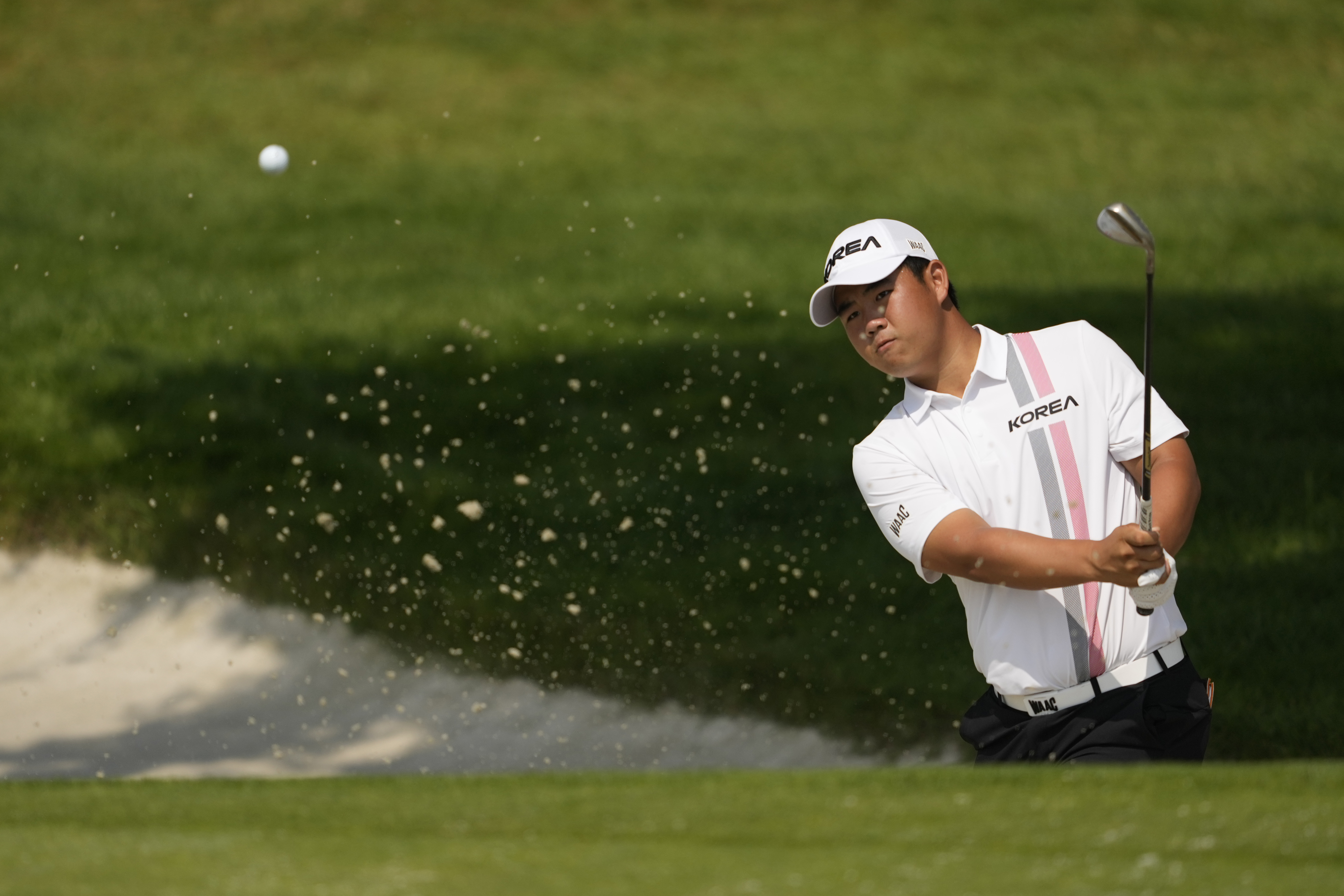 Tom Kim, of South Korea, plays from a bunker on the 3rd green during the second round of the men's golf event at the 2024 Summer Olympics, Friday, Aug. 2, 2024, at Le Golf National in Saint-Quentin-en-Yvelines, France.