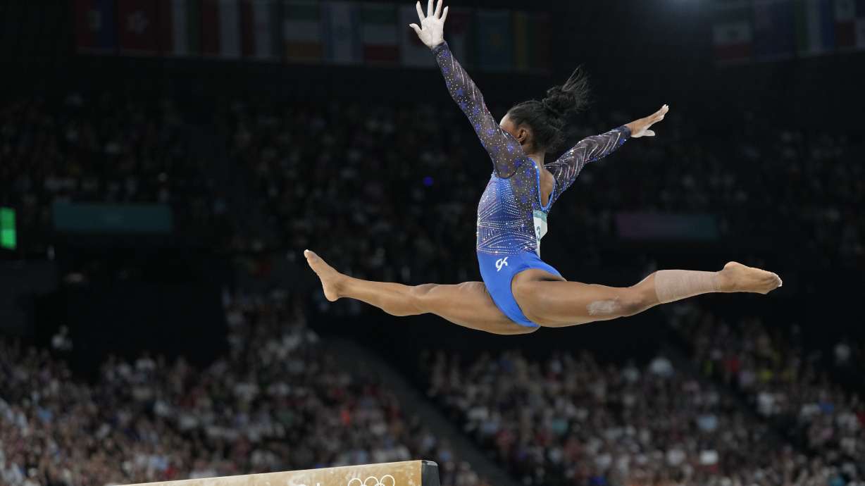 Simone Biles, of the United States, performs on the balance beam during the women's artistic gymnastics all-around finals in Bercy Arena at the 2024 Summer Olympics, Thursday, Aug. 1, 2024, in Paris, France.