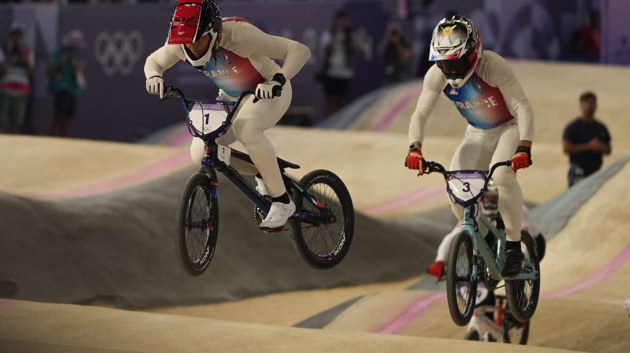 Joris Daudet of France leads Sylvain Andre of France during a BMX racing event, at the 2024 Summer Olympics, Friday, Aug. 2, 2024, in Saint-Quentin-en-Yvelines, France.