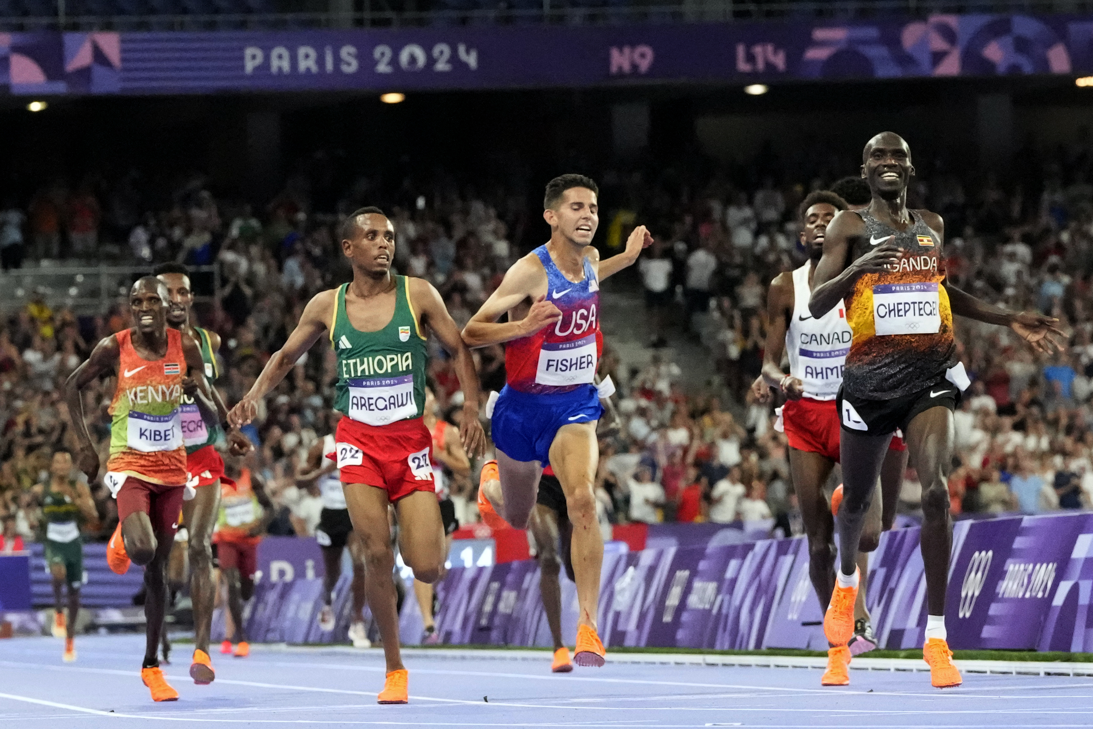 Joshua Cheptegei, of Uganda, celebrates after winning the men's 10,000-meter final at the 2024 Summer Olympics, Friday, Aug. 2, 2024, in Saint-Denis, France. 