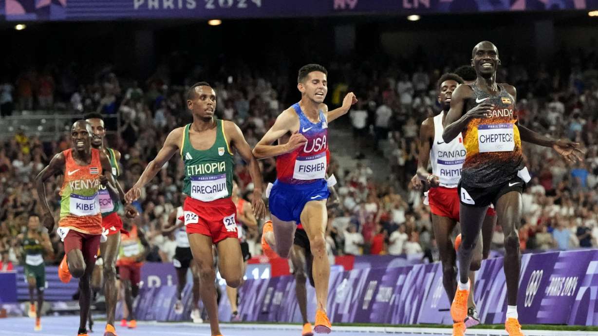 Joshua Cheptegei, of Uganda, celebrates after winning the men's 10,000-meter final at the 2024 Summer Olympics, Friday, Aug. 2, 2024, in Saint-Denis, France.