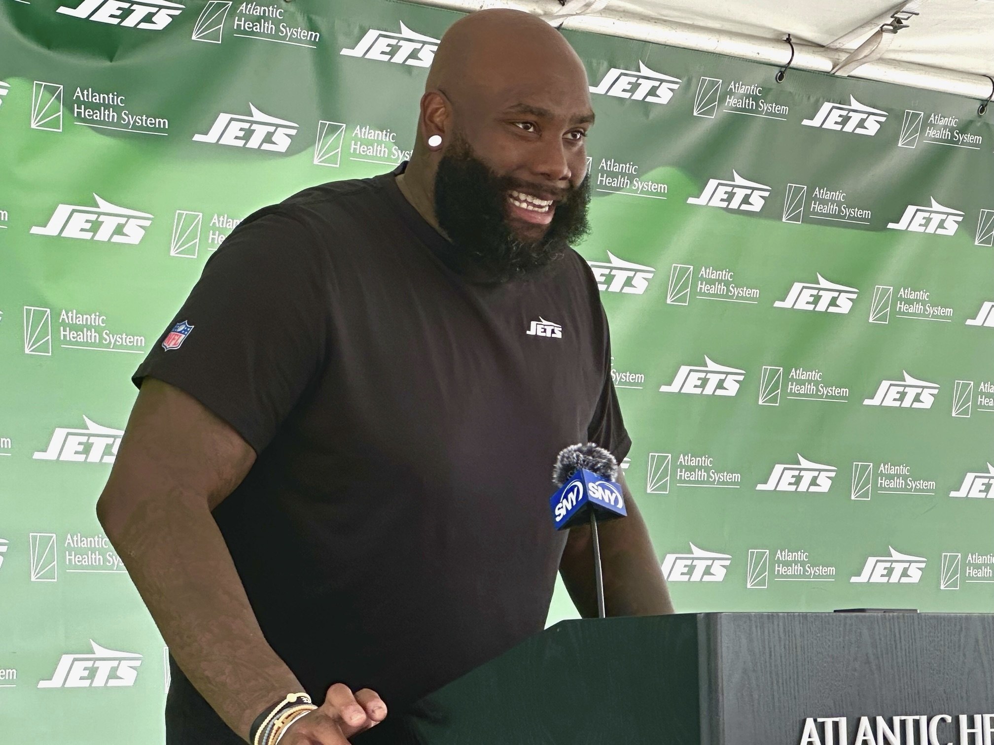 New York Jets offensive tackle Morgan Moses speaks to reporters after his first training camp practice in Florham Park, N.J., Friday, Aug. 2, 2024. 