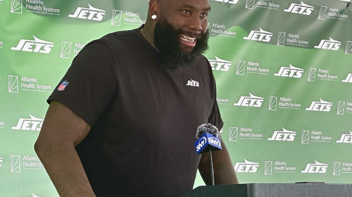 New York Jets offensive tackle Morgan Moses speaks to reporters after his first training camp practice in Florham Park, N.J., Friday, Aug. 2, 2024.