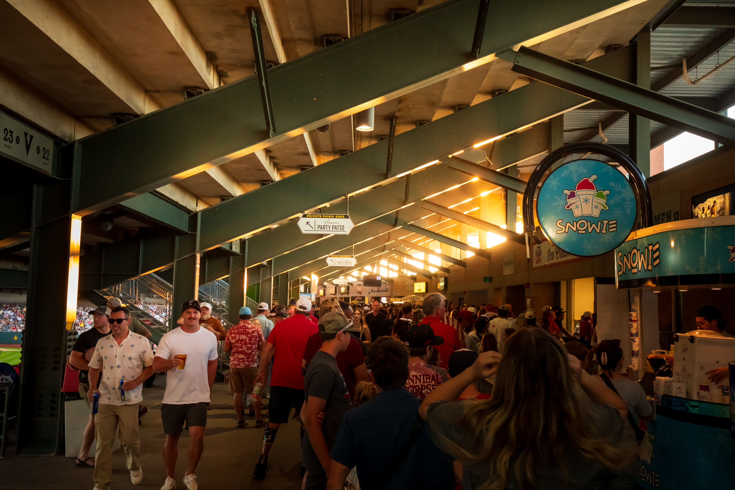 Fans walk through the Smith's Ballpark concourse during a game between the Salt Lake Bees and Tacoma Rainers on July 4.