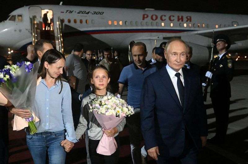 Russian President Vladimir Putin welcomes Russian nationals, including Artyom Dultsev, Anna Dultseva and their children, following a prisoner exchange between Russia with Western countries, during a ceremony at Vnukovo International Airport in Moscow, Russia Thursday.