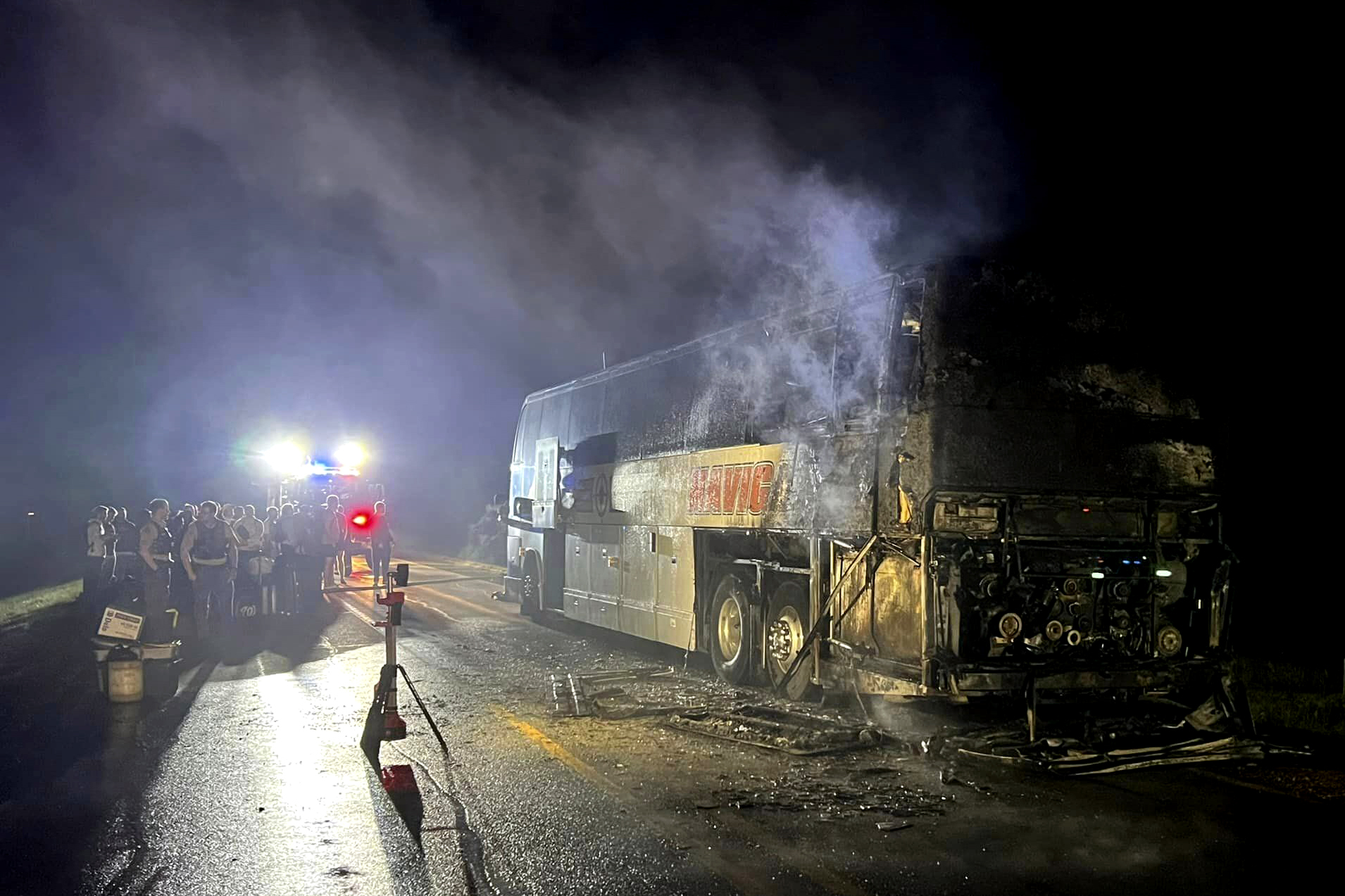 In this photo provided by J.D. Scholten, a bus carrying the Sioux City Explorers to a baseball game in Illinois caught fire early on Friday, Aug. 2, 2024, near Earlham, Iowa. State Rep. J.D. Scholten, who is a pitcher for the team, wrote in a Facebook post that he was grateful no one was hurt.