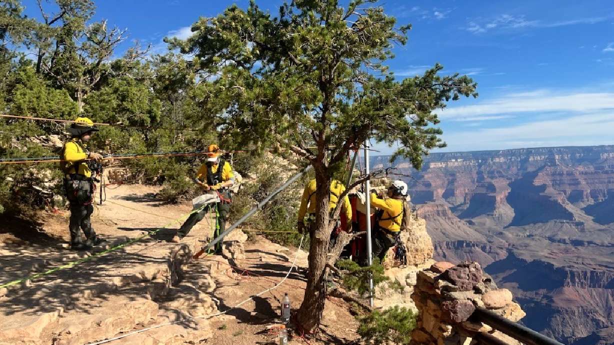 Grand Canyon National Park first responders manage a high-angle technical rescue system on Friday to recover the body of a BASE jumper who died in an apparent crash near Yavapai Point on Thursday.