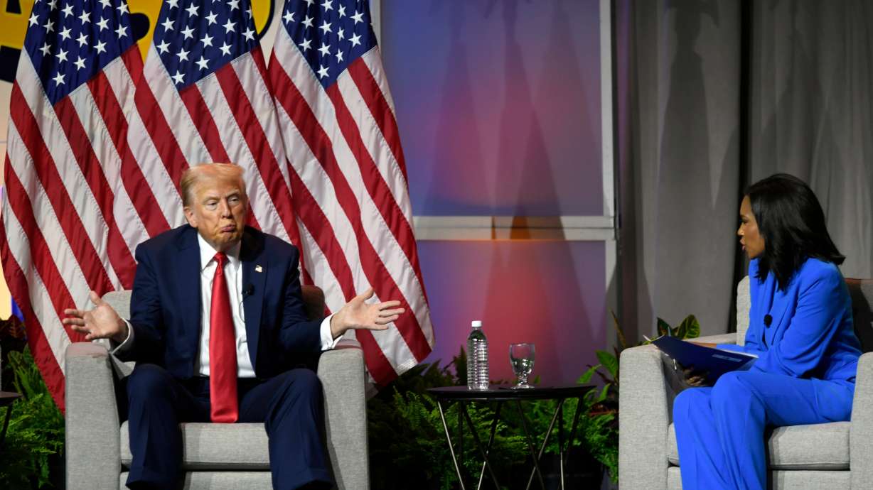 Republican presidential candidate former President Donald Trump, left, participates in a discussion at the National Association of Black Journalists Convention and Career Fair in Chicago Wednesday. On the right is ABC's Rachel Scott.